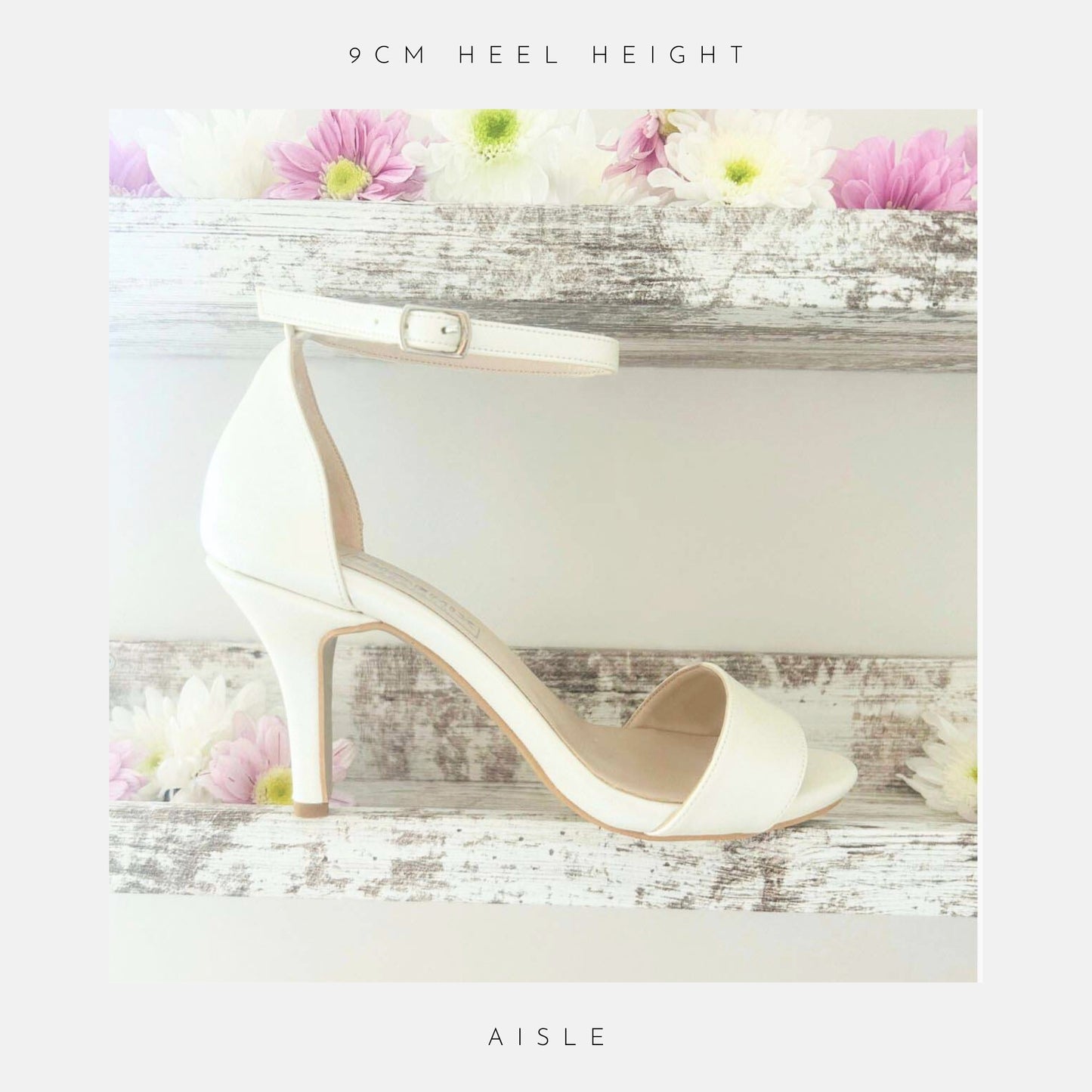 An open toe high heel ivory bridal shoe shown on a shelf with pretty flowers.