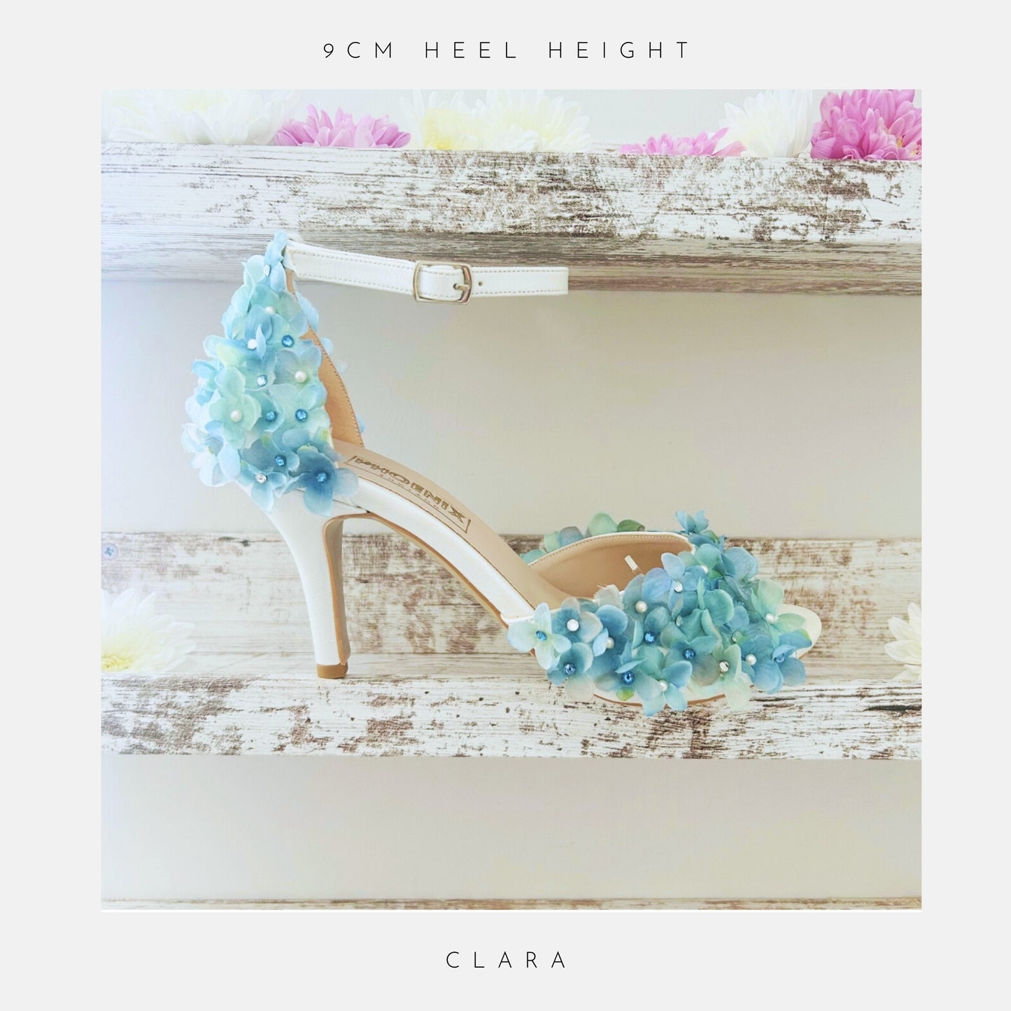 High-heeled shoe with floral design on a wooden surface, labelled '9cm heel height' and 'Clara'.
