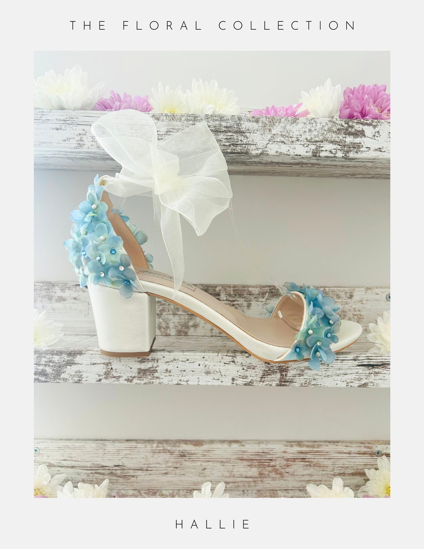 Ivory bridal sandal with floral decorations on a wooden surface with flowers in the background, labelled 'The Floral Collection' and 'Hallie'.