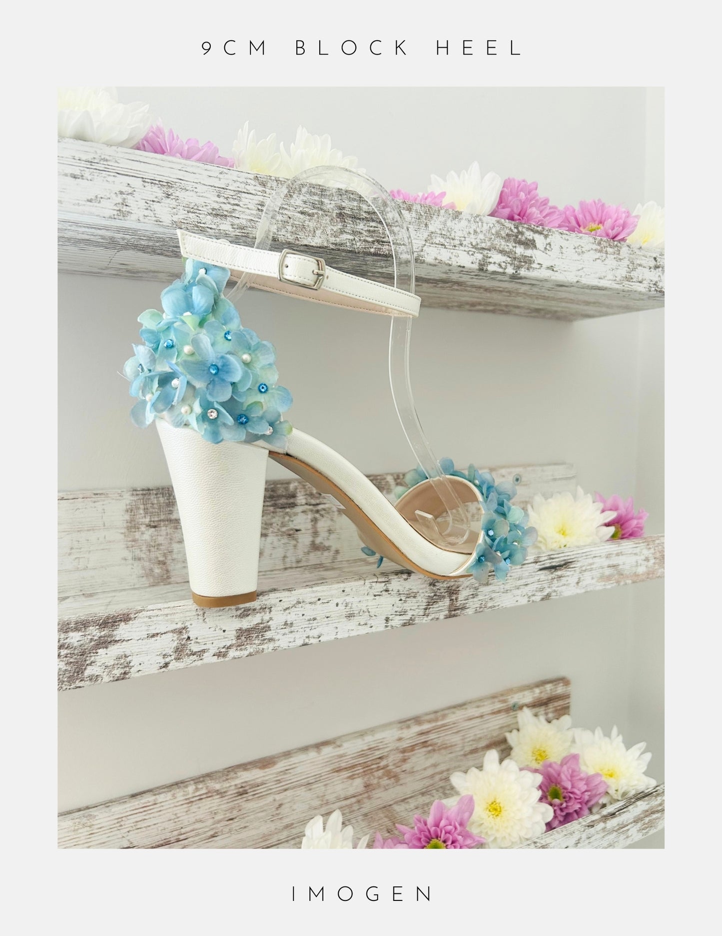 Ivory high-heeled block heel bridal shoe with blue floral decorations on a wooden shelf with flowers.