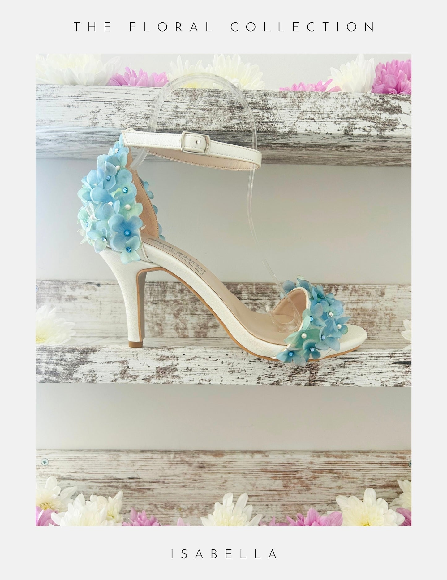 Ivory bridal sandal with floral decorations on a wooden surface, labelled 'The Floral Collection' and 'Isabella'.