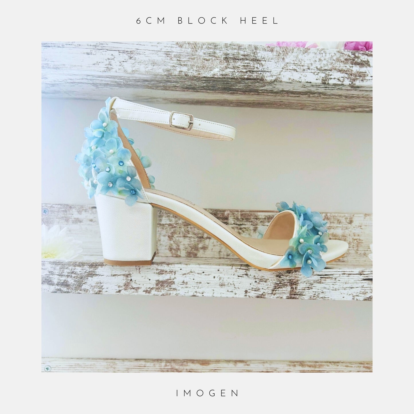 The Rosa Floral Low Block Heel Bridal Shoes by Phoenix England, an ivory sandal with blue hydrangea flowers, ankle strap.