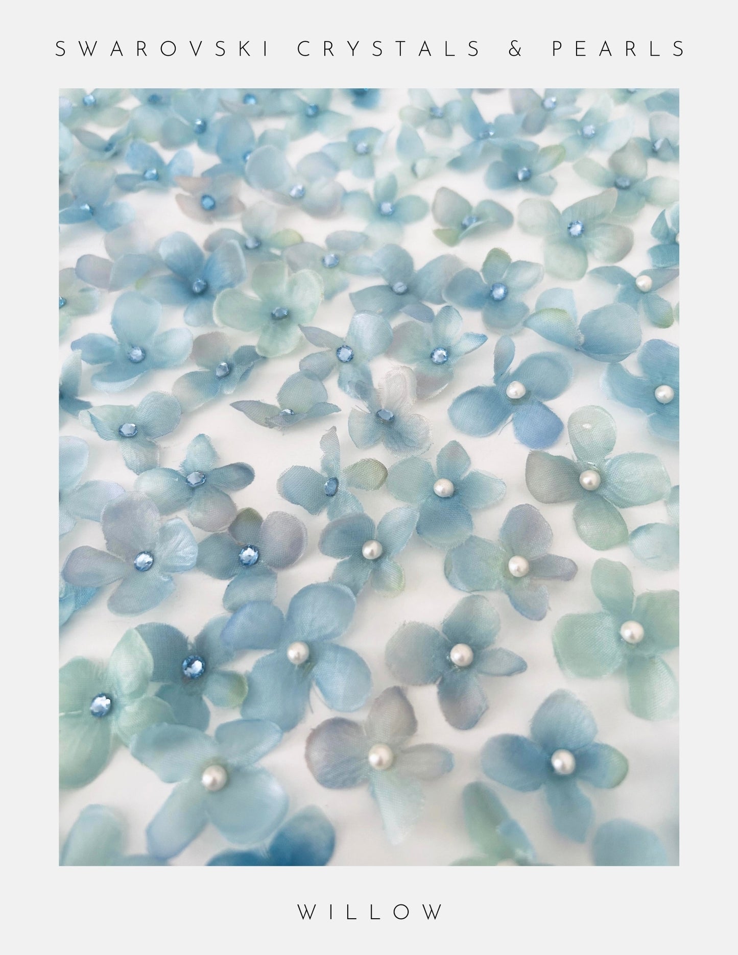 Blue floral decorations with Swarovski crystals and pearls on a white background