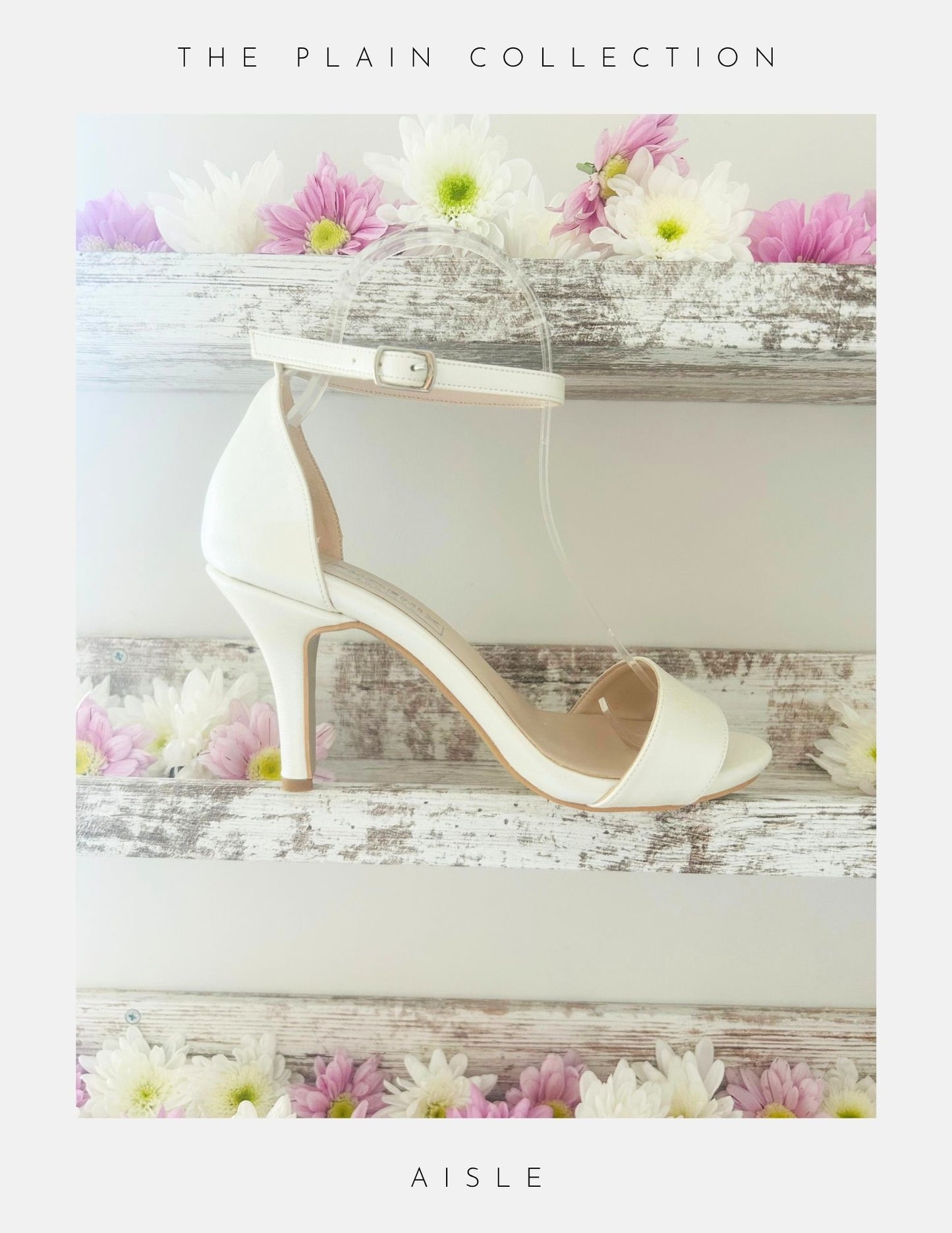 An open toe high heel ivory bridal shoe shown on a shelf with pretty flowers.