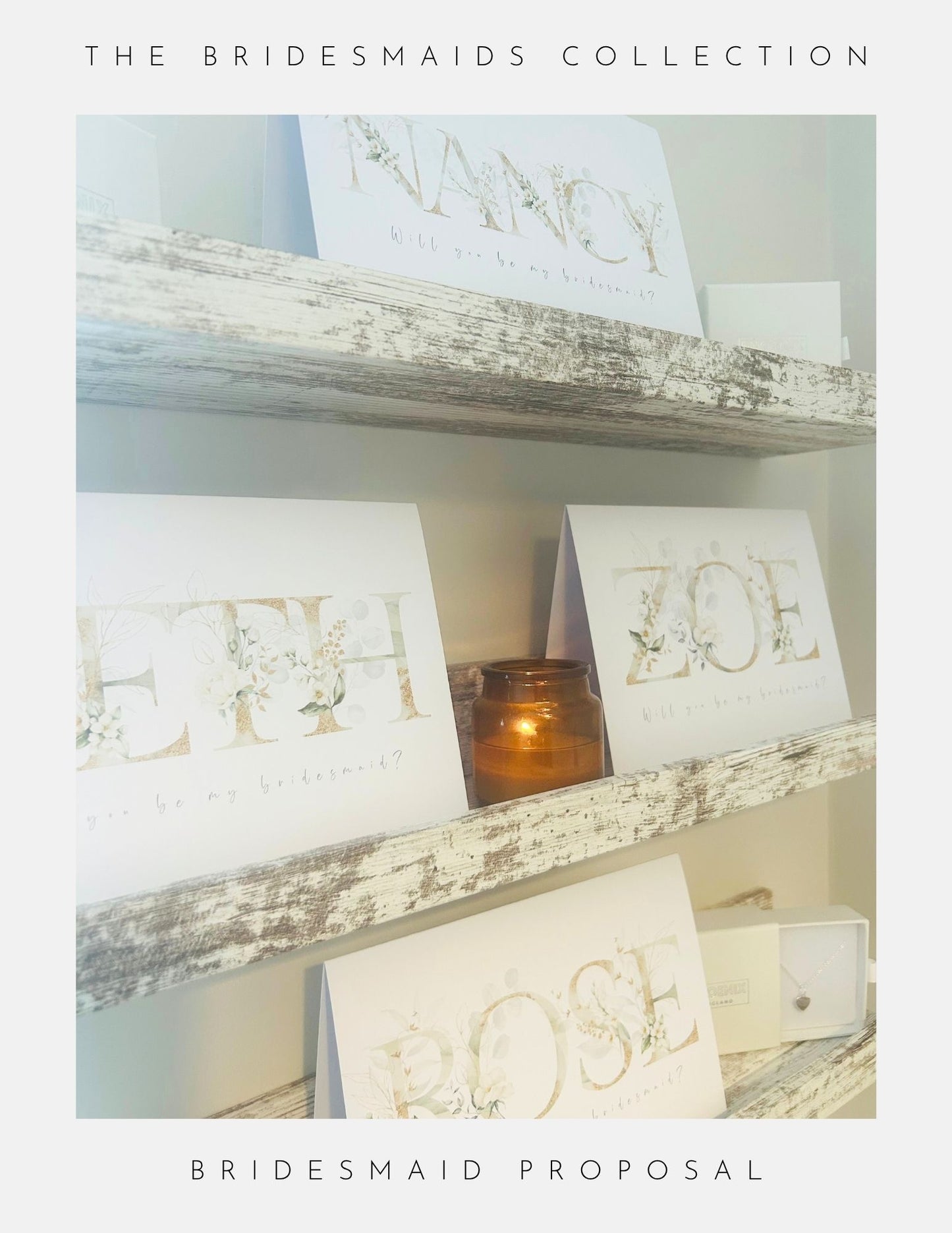 White cards with floral lettering display “NANCY,” “ZOE,” “BETH,” and “ROSE” on rustic shelves beside a candle, showcasing Phoenix England’s Be My Bridesmaid Gifts collection. Framing text highlights this charming bridesmaid proposal idea.