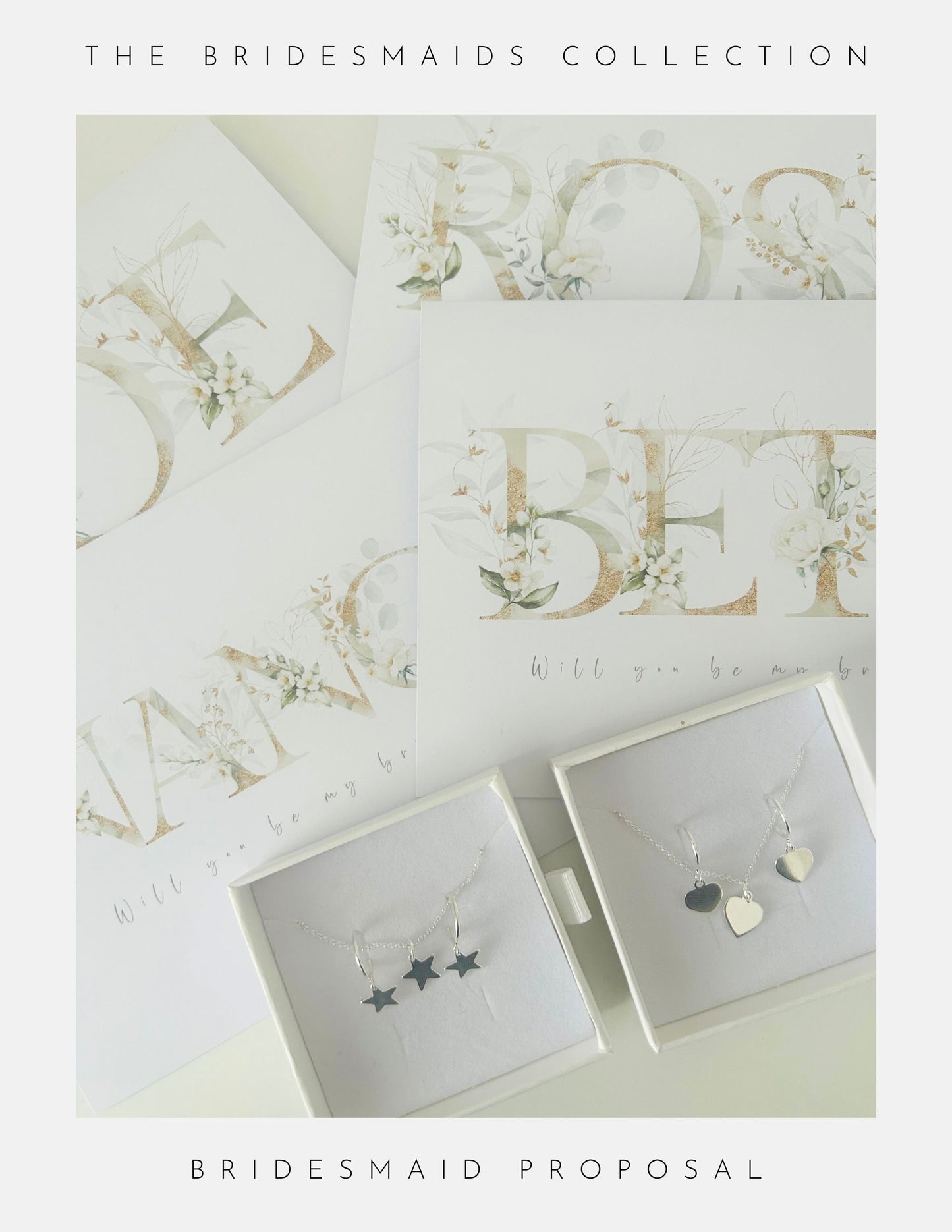 Flat lay of Phoenix England Be My Bridesmaid Gifts: proposal cards with floral lettering, next to two white sterling silver jewellery boxes—one with three star charms, the other with two heart charms.
