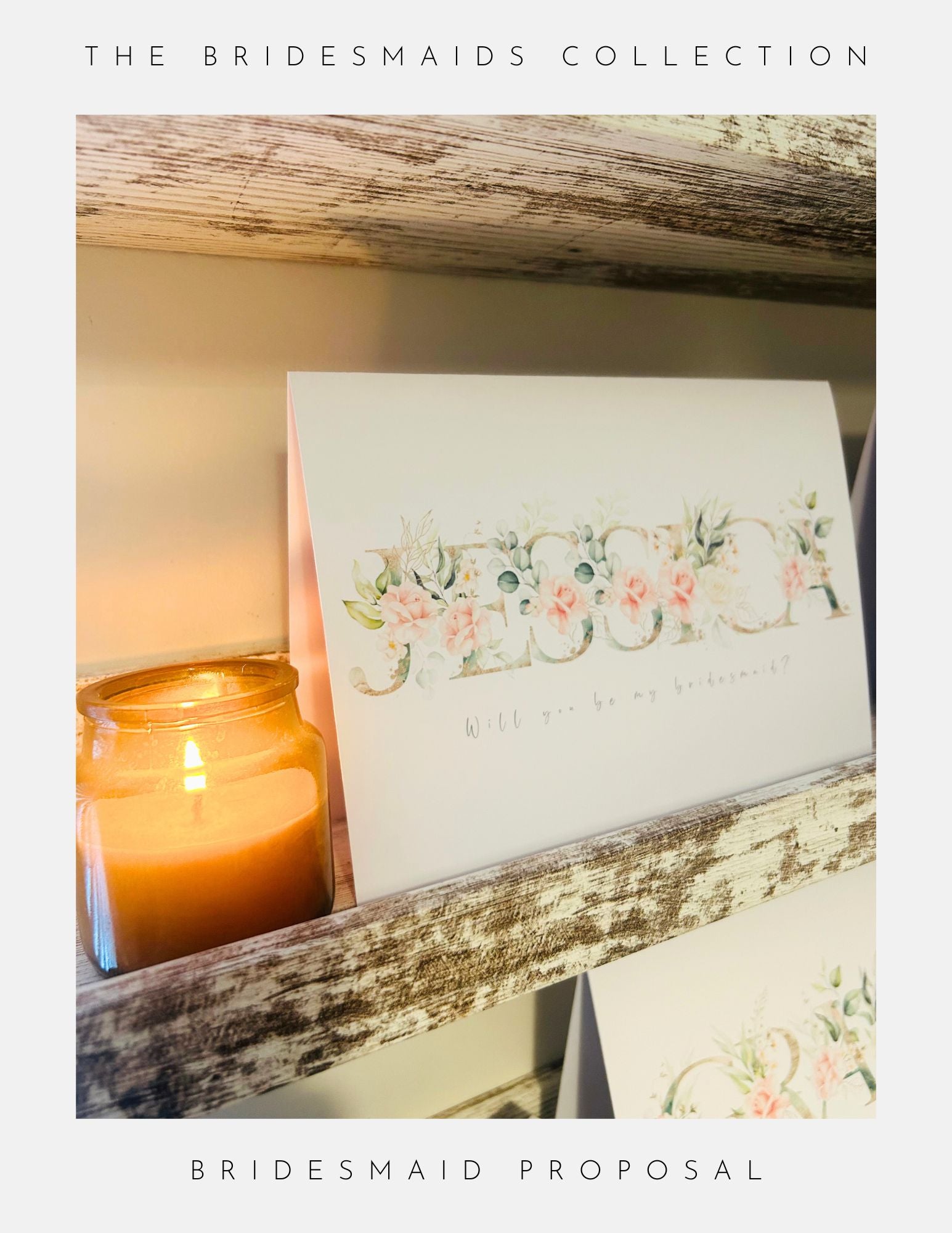 A Bridesmaids Proposal Ideas Sterling Silver card by Phoenix England sits on a rustic wooden shelf beside a candle, showcasing bespoke craftsmanship and unique gifts from The Bridesmaids Collection.
