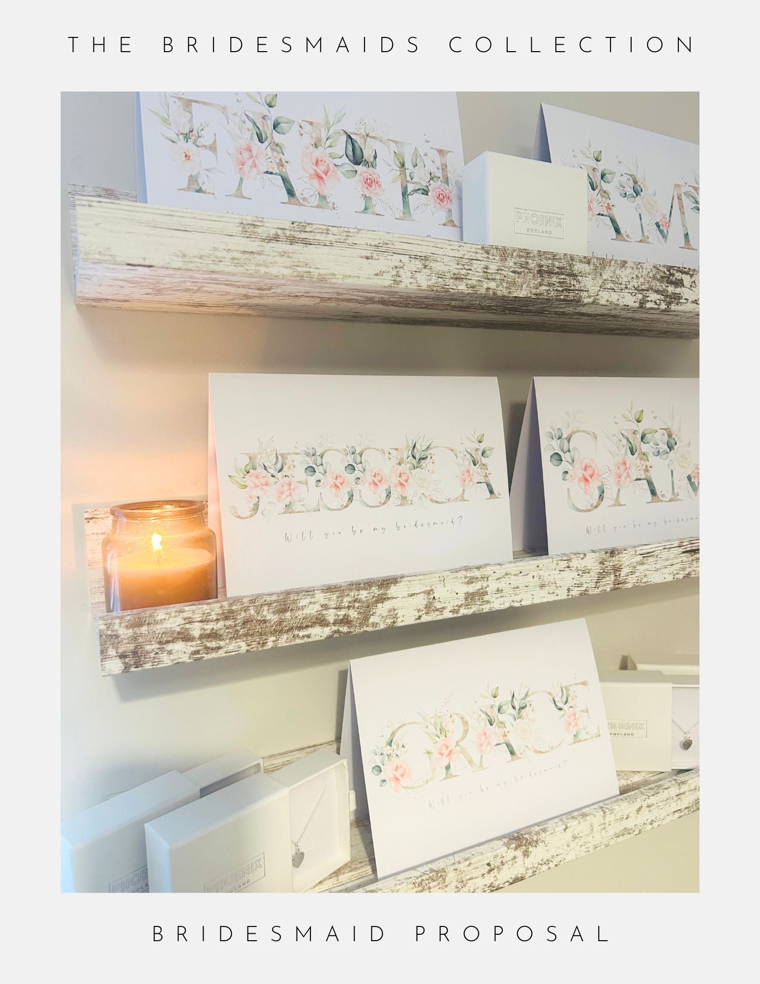 Two rustic shelves showcase Phoenix Englands Bridesmaids Proposal Ideas Sterling Silver gifts, featuring floral Will you be my bridesmaid? cards, matching boxes, and a lit jar candle—perfect for an elegant, bespoke proposal.