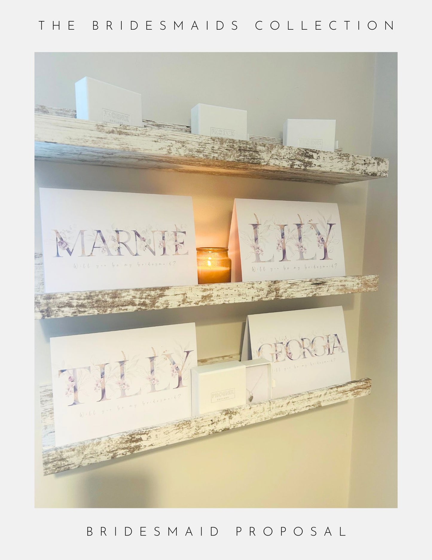 A display of white cards with pastel floral lettering spelling Marnie, Lily, Tilly, and Georgia on rustic shelves, with white boxes and a candle. Text reads: Bridesmaids Proposal Sterling Silver by Phoenix England.