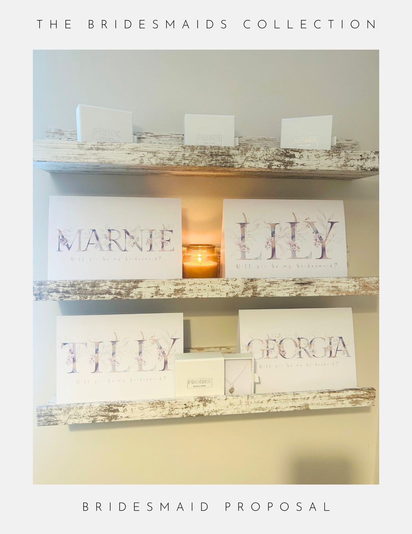 Two rustic white wooden shelves display Phoenix England Bridesmaids Proposal Sterling Silver cards with names (Marnie, Lily, Tilly, Georgia) and gift boxes. A lit candle sits in the center. Text frames the image—perfect for wedding moments.