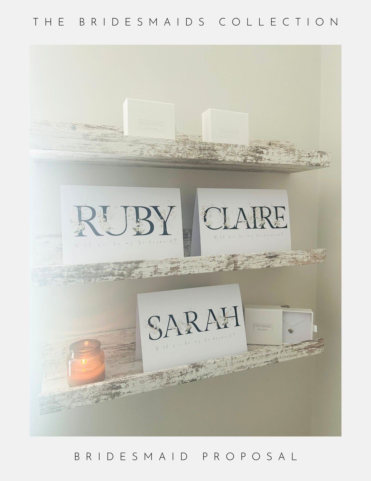 Three rustic shelves hold white boxes and Phoenix England Bridesmaids Proposal Cards labeled RUBY, CLAIRE, SARAH with Will you be my bridesmaid? A lit candle glows below, creating a softly lit scene perfect for gifting sterling silver jewelry.