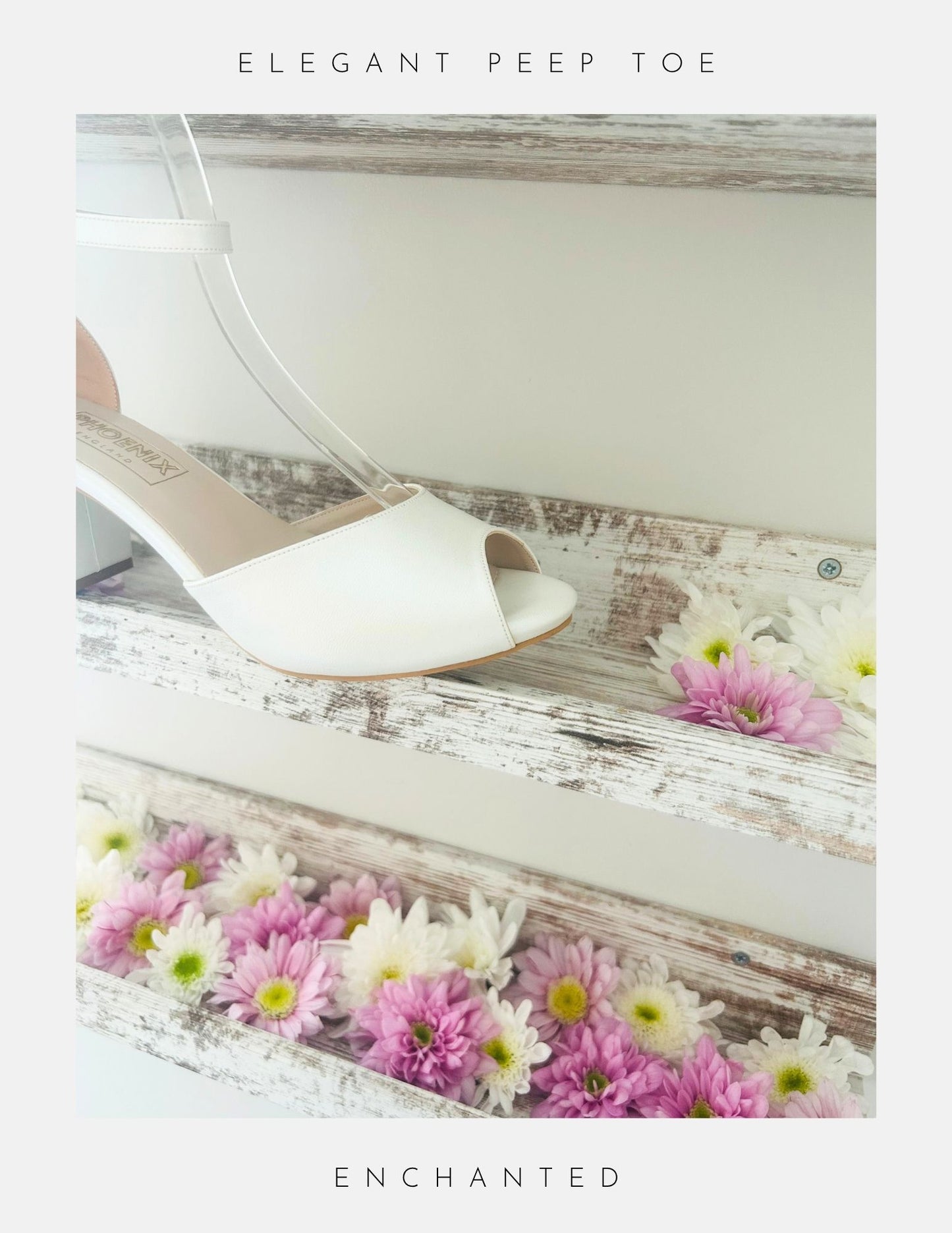 The Enchanted Peep Toe Low Bridal Shoes from Phoenix England, crafted in pearl ivory vegan leather, sit on top of a rustic wooden shelf with pink and white flowers.