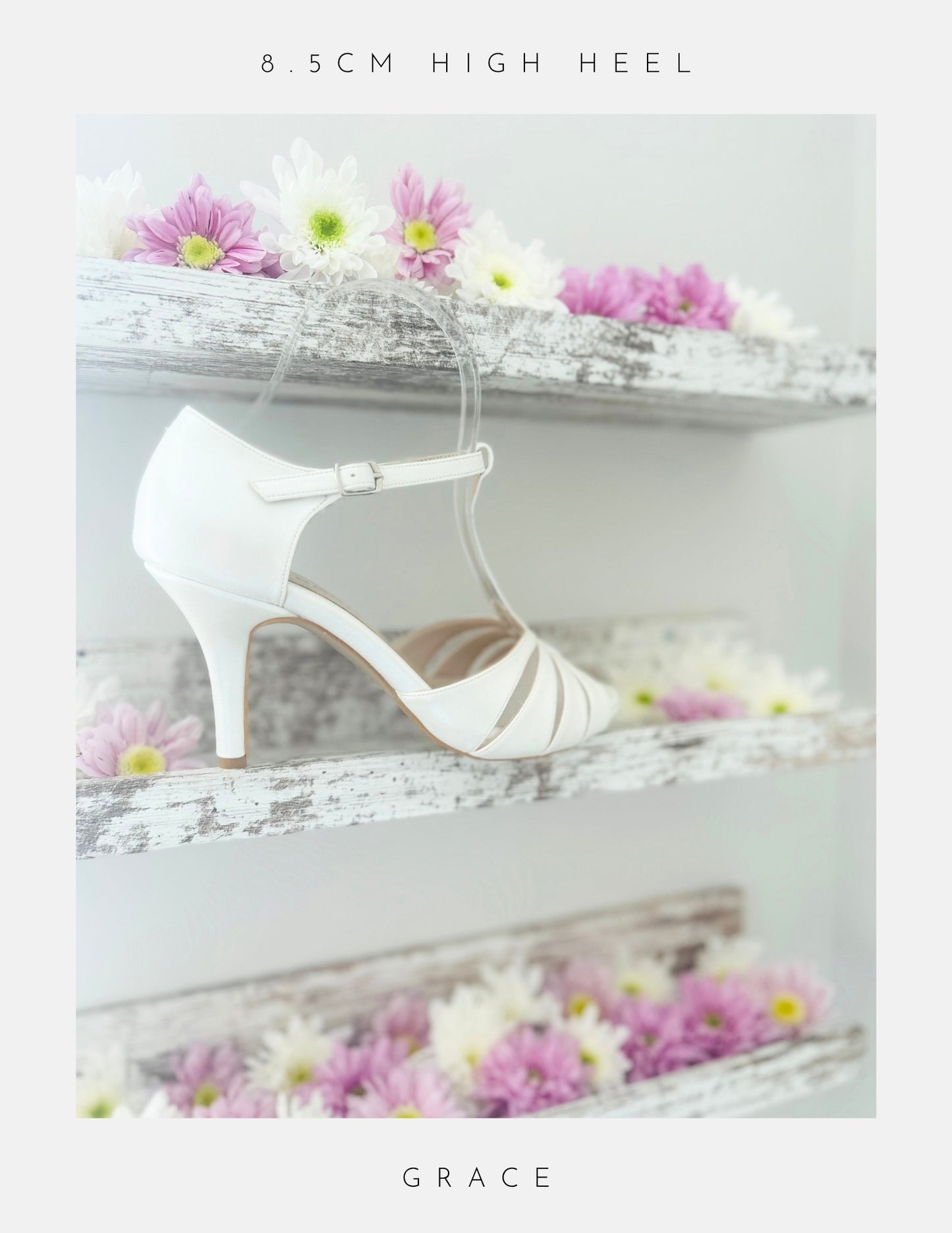 Ivory high-heeled bridal shoe with 'GRACE' branding on a decorative background with flowers.