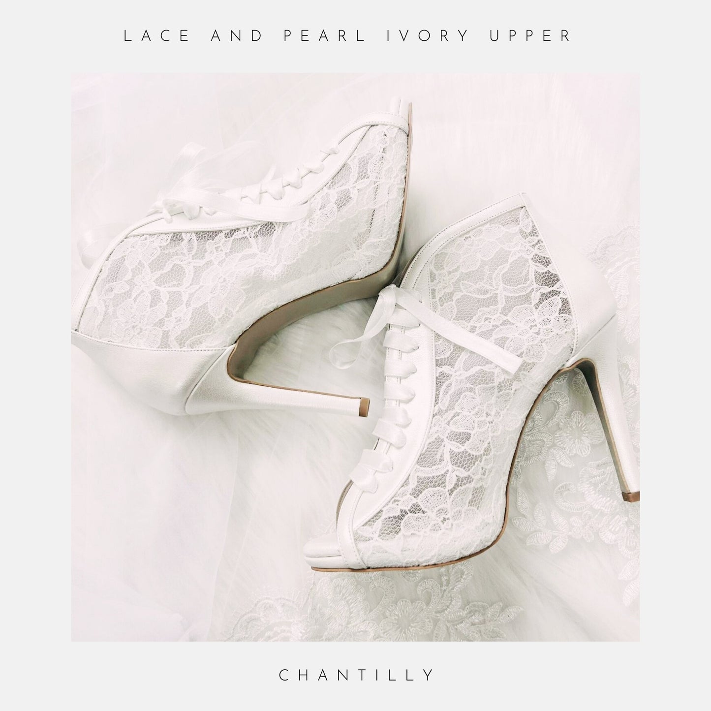 The Phoenix England Chantilly Wedding Shoes feature white Chantilly lace, ribbon laces, and peep toes, beautifully displayed on sheer, delicate fabric.