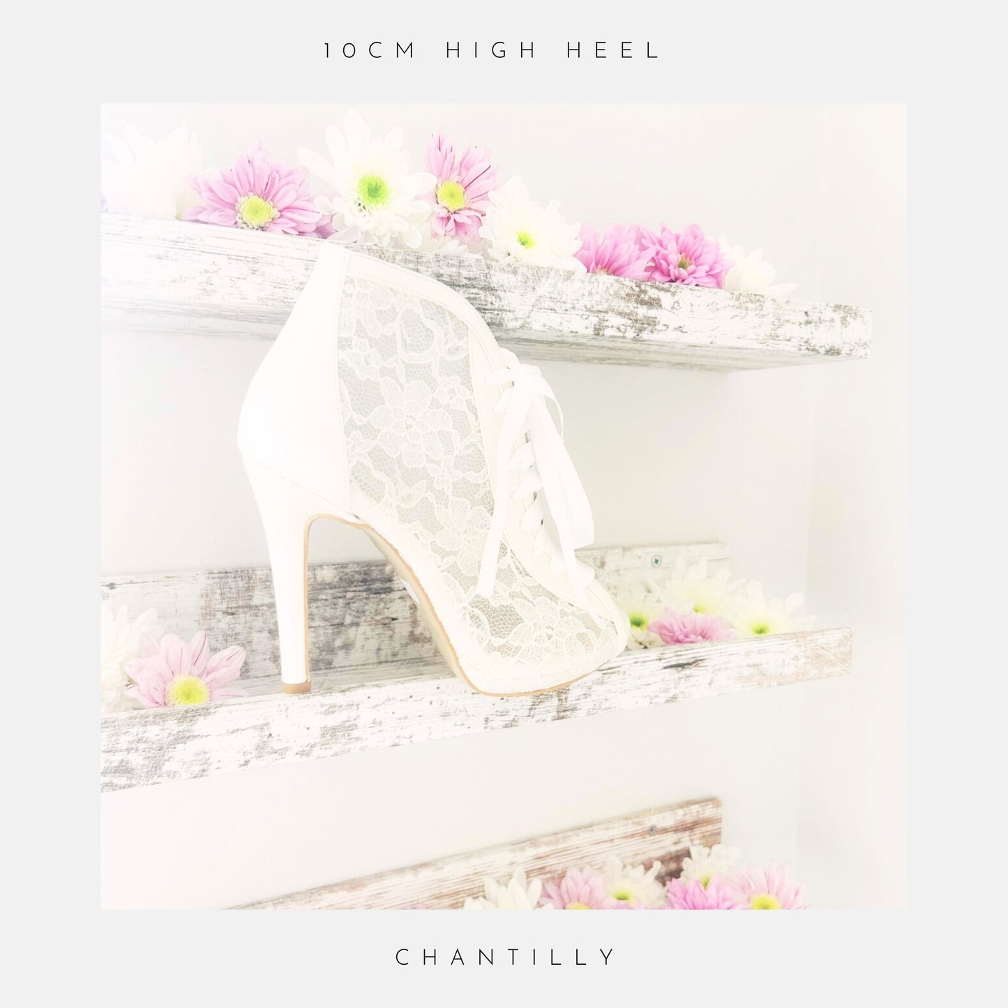 Ivory lace high heel bridal boot on a decorative shelf with flowers, with the wording 10cm heel height and Chantilly