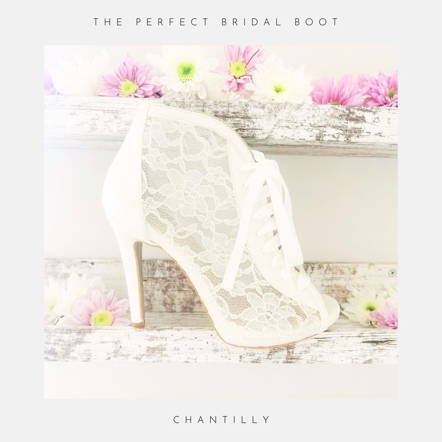 Ivory lace boot with floral decorations on a wooden surface