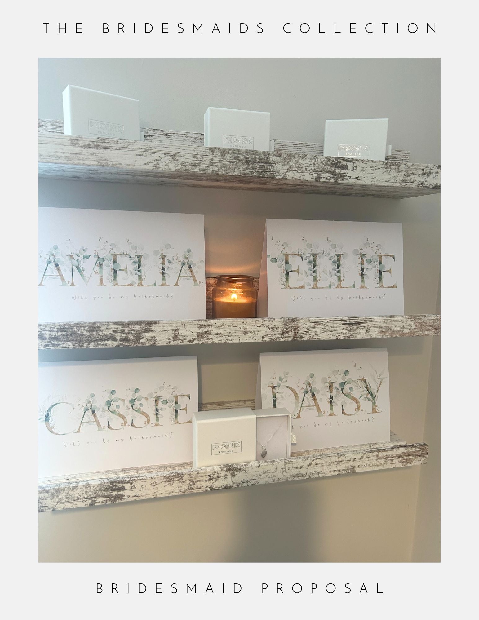Three rustic shelves showcase Phoenix Englands Maid Of Honour Proposal Sterling Silver gift boxes—with white boxes, candles, and sterling silver jewellery—labeled AMELIA, ELLIE, CASSIE, and DAISY under “The Bridesmaids Collection.”.