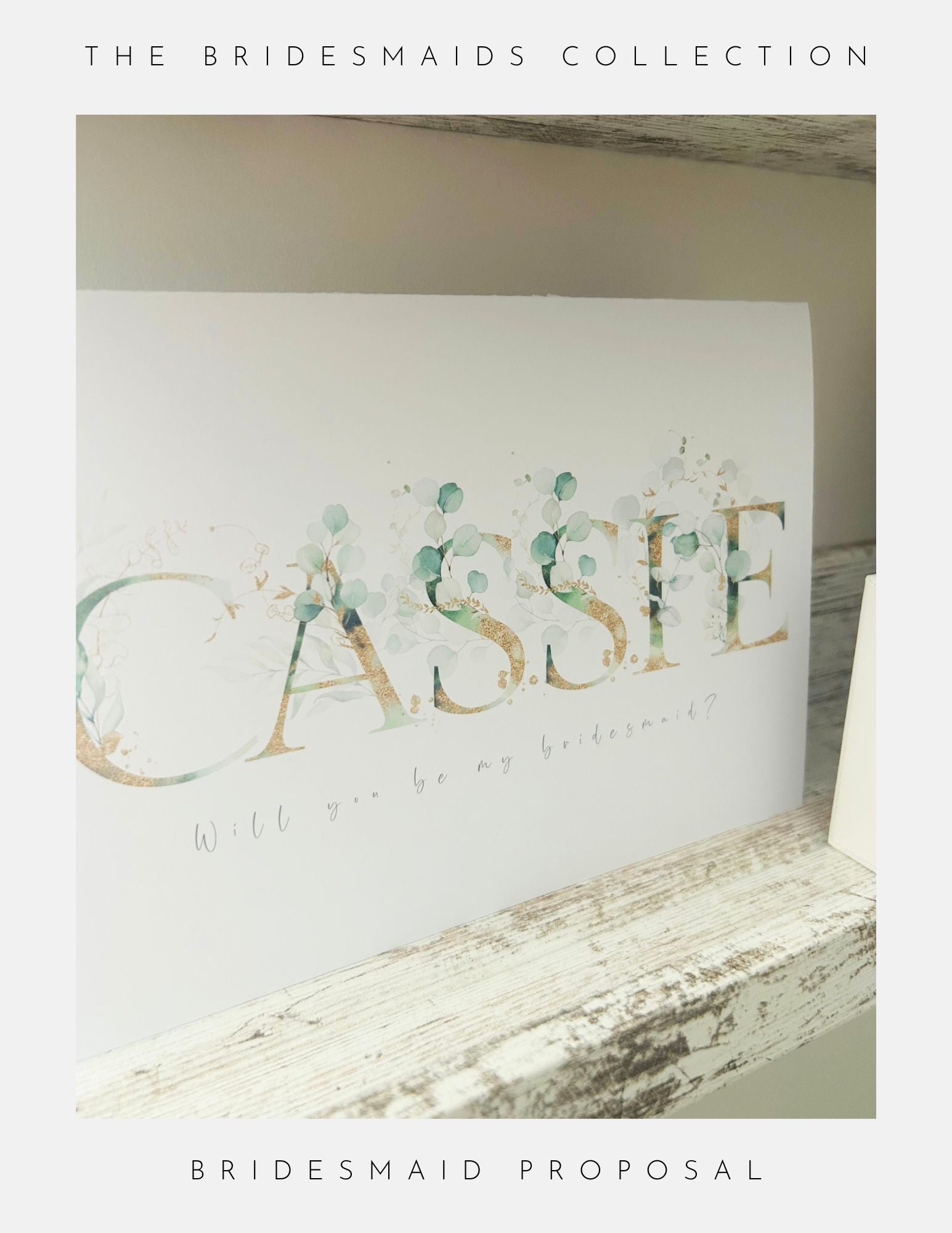 A card with Cassie in floral letters and Will you be my bridesmaid? sits on a rustic wooden shelf. From Phoenix England, the Maid Of Honour Proposal Sterling Silver is a charming choice for your special proposal.