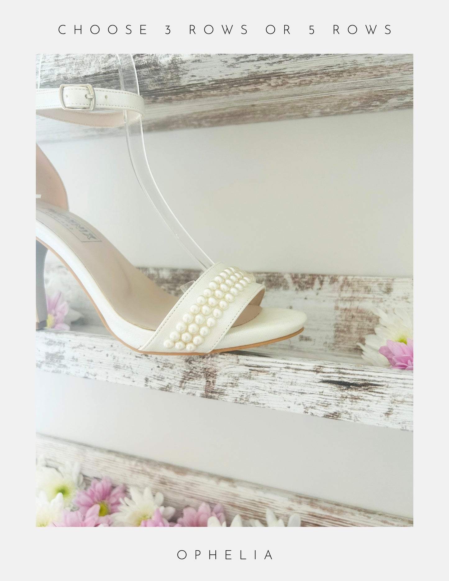 The Ophelia Pearl High Heel Wedding Shoes by Phoenix England, displayed on a rustic white shelf with pink and white flowers. Choose 3 or 5 rows of crystal pearls—perfect bridal heels for your special day.