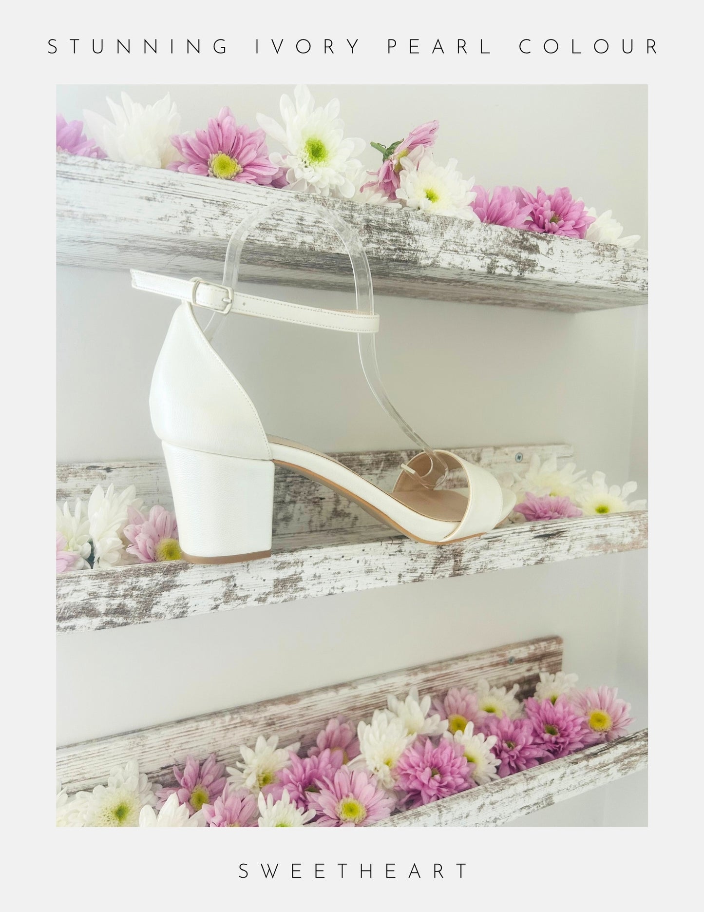 Ivory high-heeled shoe on a wooden surface with flowers, labelled 'Sweetheart'.