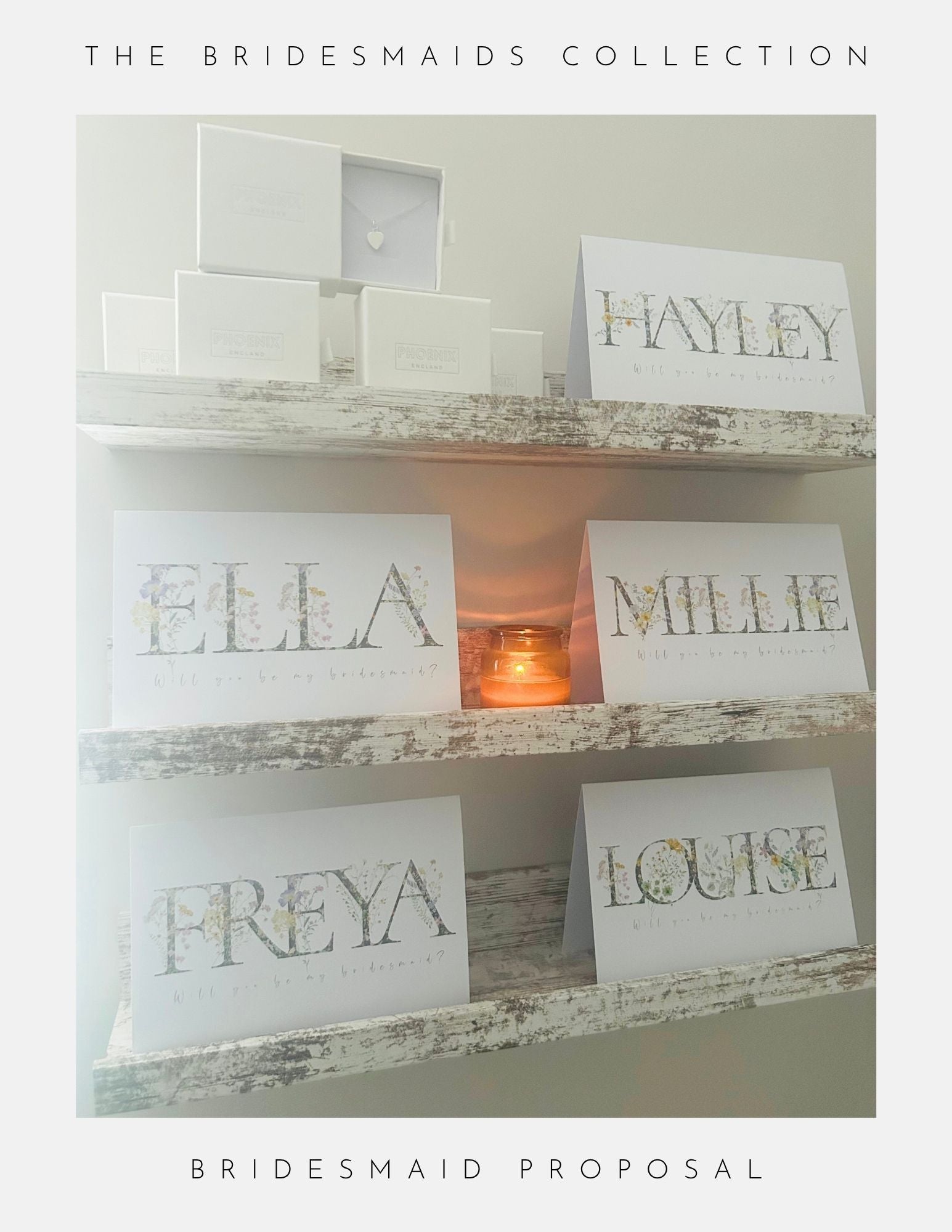 A rustic white shelf presents Phoenix England’s Thank You Bridesmaid Gift Ideas, including floral bridesmaid proposal cards with names (Hayley, Ella, Millie, Freya, Louise), jewellery, gift boxes, and a softly glowing candle.