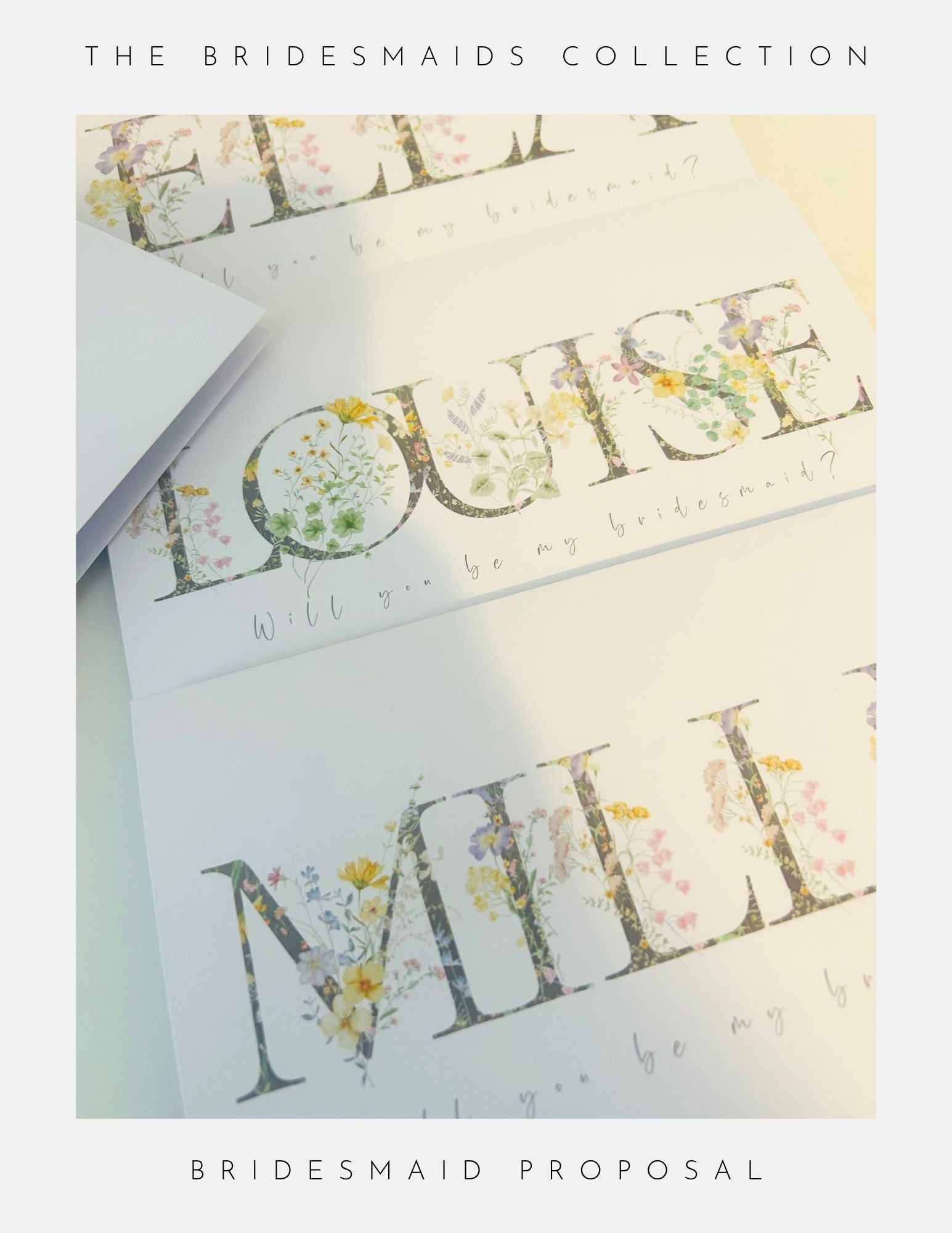 Three white bridesmaid proposal cards by Phoenix England feature floral designs and large names like LOUISE and MILLIE, with “Will you be my bridesmaid?” in script, a perfect Thank You Bridesmaid Gift Idea.