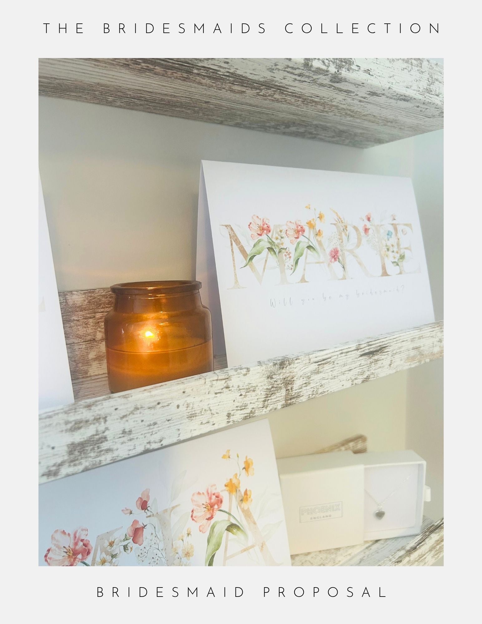 A brown candle, floral bridesmaid proposal cards, and a small white jewellery box by Phoenix Englands. Will You Be My Bridesmaid Gift sets are displayed on rustic wooden shelves. Text reads: The Bridesmaids Collection. Bridesmaid Proposal.