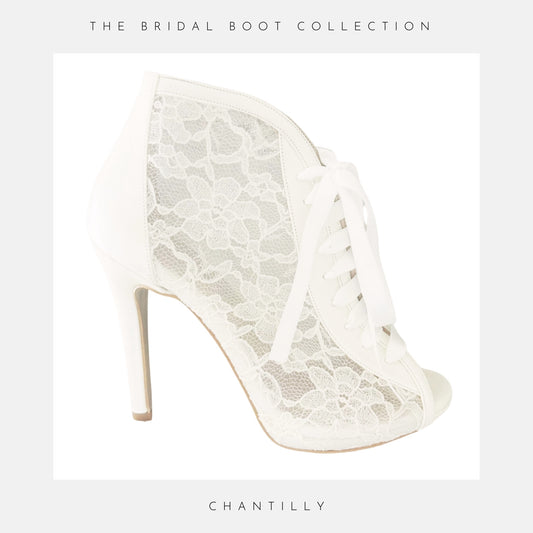 Ivory lace high-heeled wedding boot with 'The Boot Collection' branding on a light grey background.