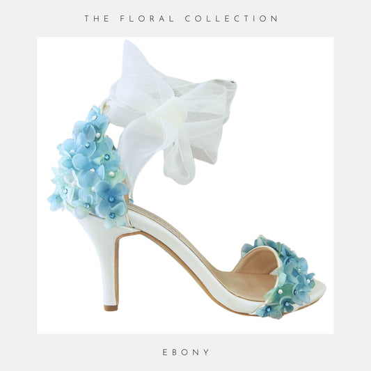 High heeled bridal shoe with organza strap, open toe and finished with pretty blue flowers.