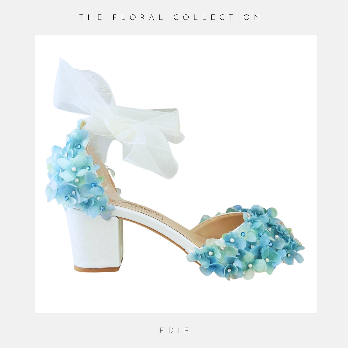 Ivory low block heeled shoes with blue floral embellishments on a white background, labelled 'The Floral Collection' and 'Edie'.