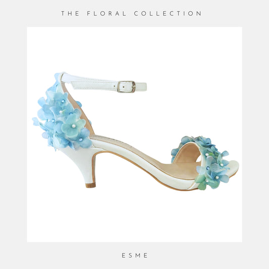 Kitten heel floral bridal shoes covered in blue hydrangeas, Text: The Floral Collection & Esme
