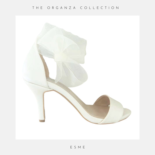 Ivory high-heeled wedding shoe with 'The Organza Collection' and 'Esme' text on a light grey background