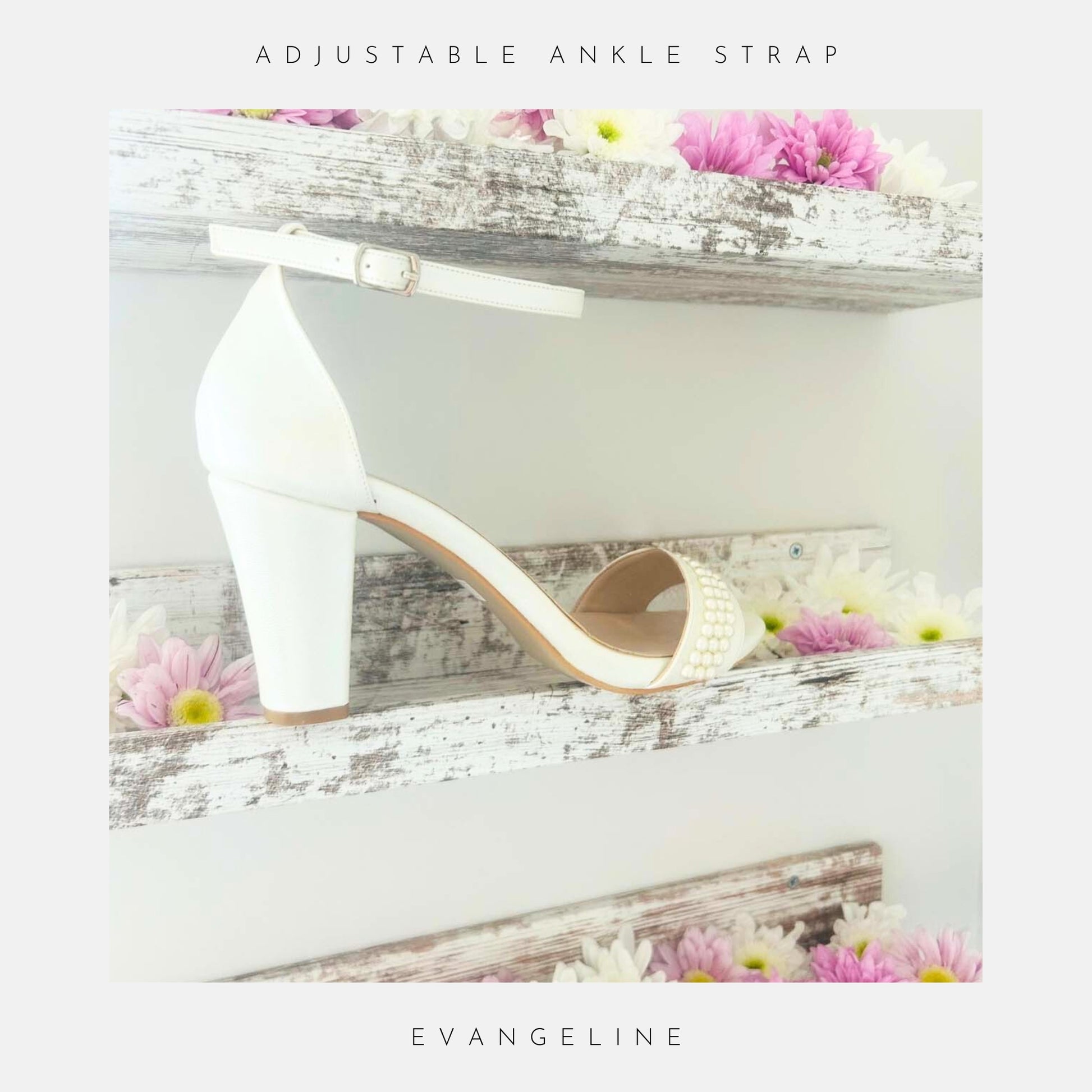 A single Evangeline Pearl Block Heel Wedding Shoe by Phoenix England, in ivory pearl, with ankle strap, sits on a rustic white shelf decorated with pink and white daisies. Text: Adjustable ankle strap and Evangeline.