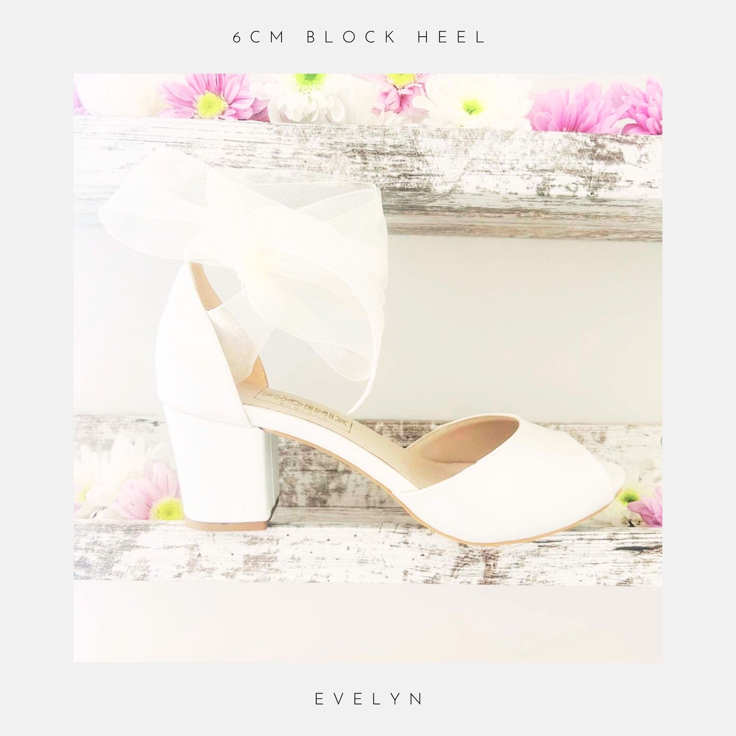 Ivory peep toe wedding shoes with a large bow and mid block heel on a floral background, featuring '6cm block heel' and 'Evelyn'.