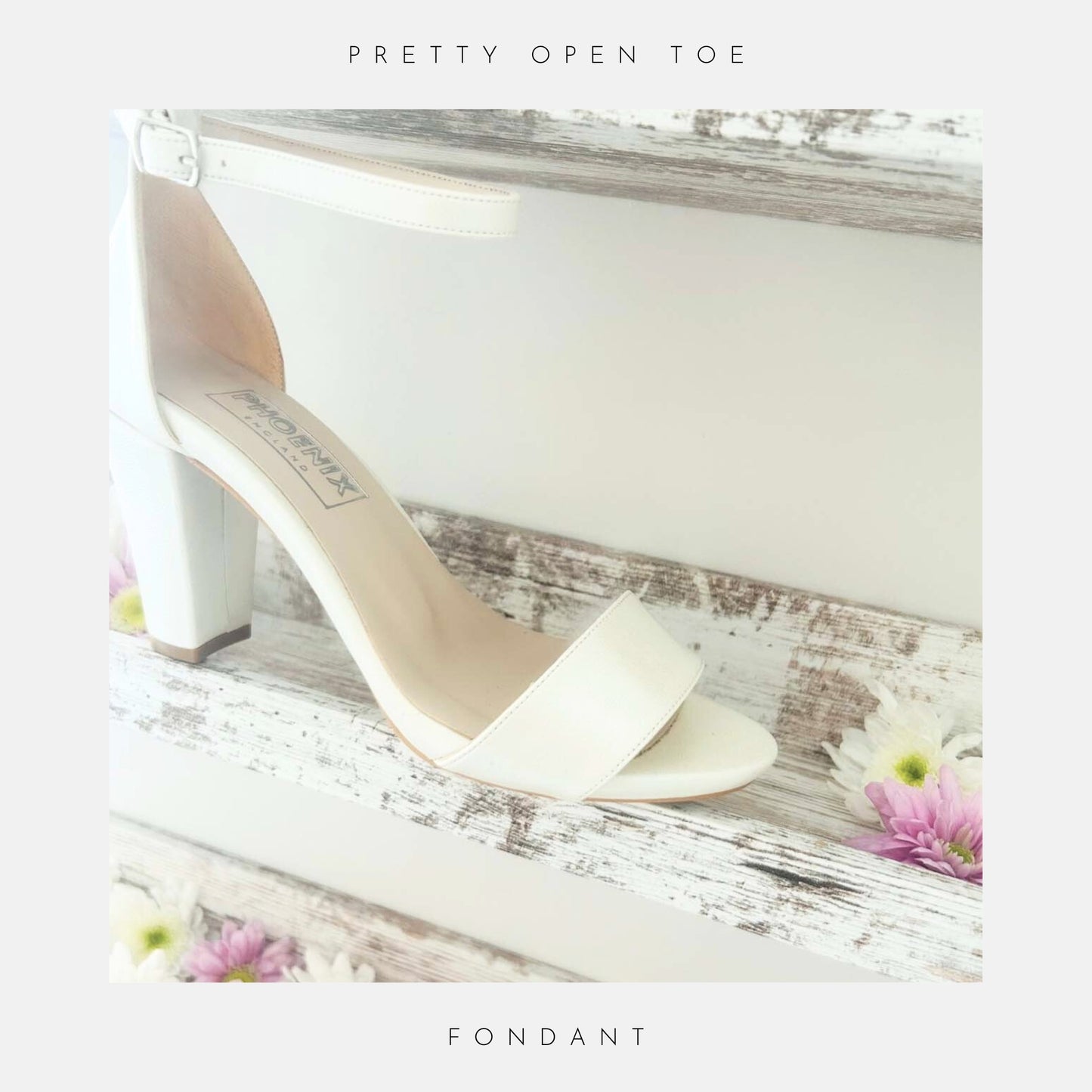 Ivory high-heeled shoe with open toe on a shelf shown with bridal flowers.