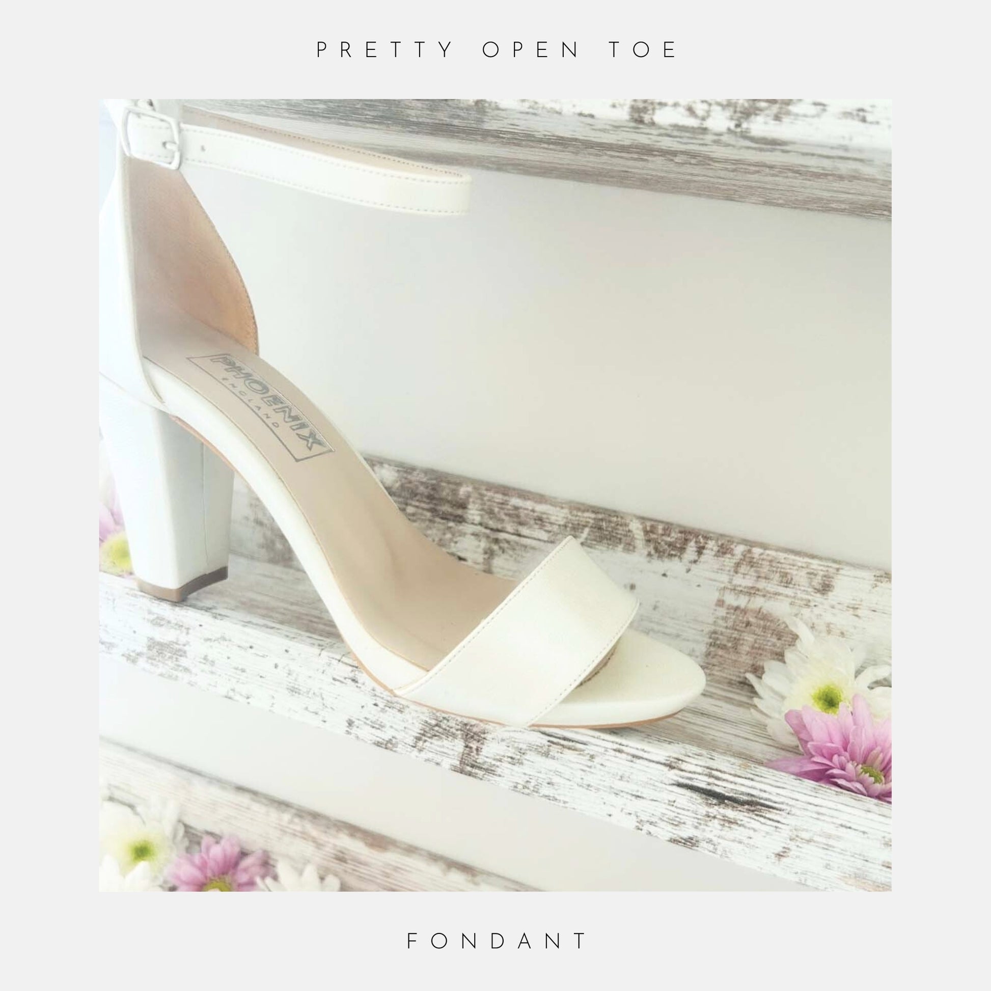 Ivory high-heeled shoe with open toe on a shelf shown with bridal flowers.