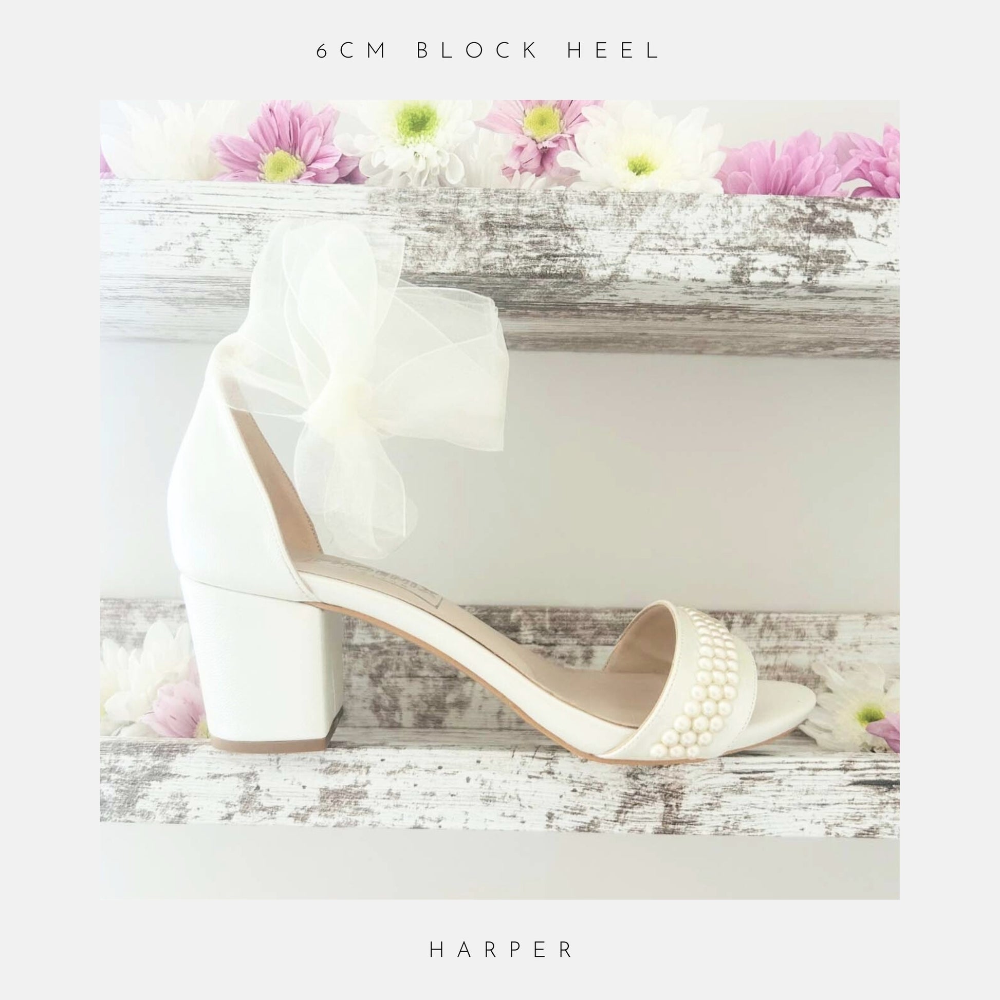 Ivory bridal sandal with pearl details on a wooden surface with flowers, labelled 'The Organza Collection' and 'Harper'.