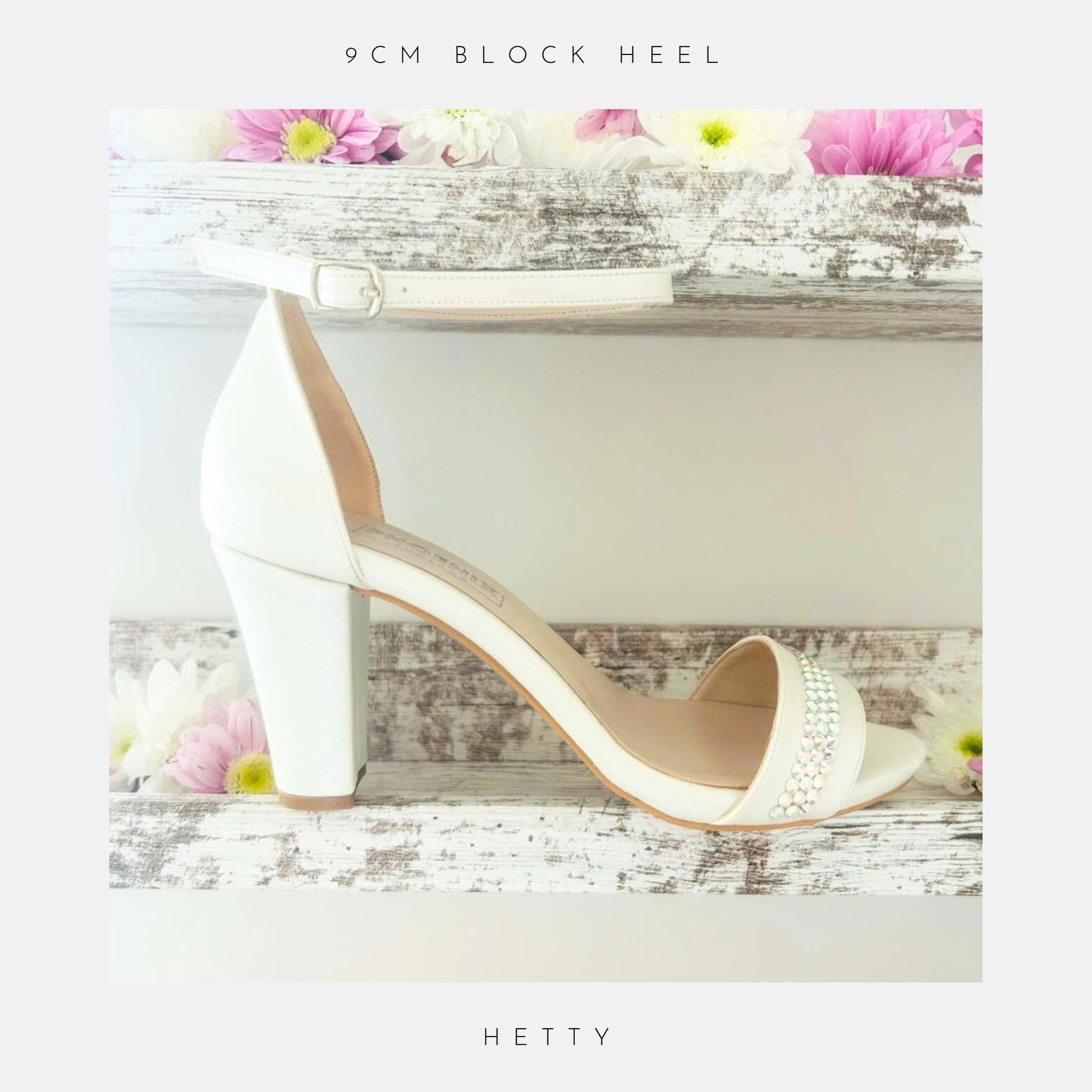 Ivory high-heeled block heel wedding shoe with crystal embellishments on a decorative background with flowers.