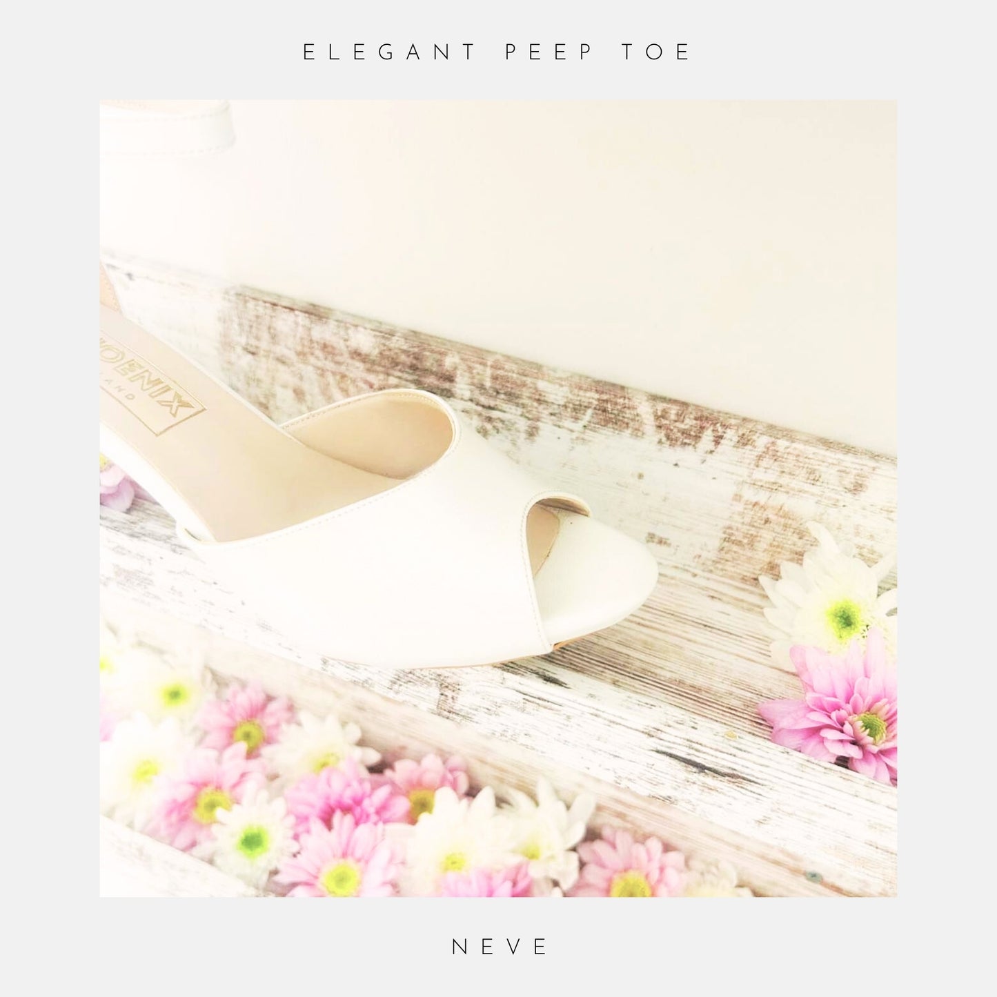 Close up of peep toe ivory kitten heel bridal shoe on a wooden surface with flowers, labelled 'Elegant Peep Toe' and 'Neve'.