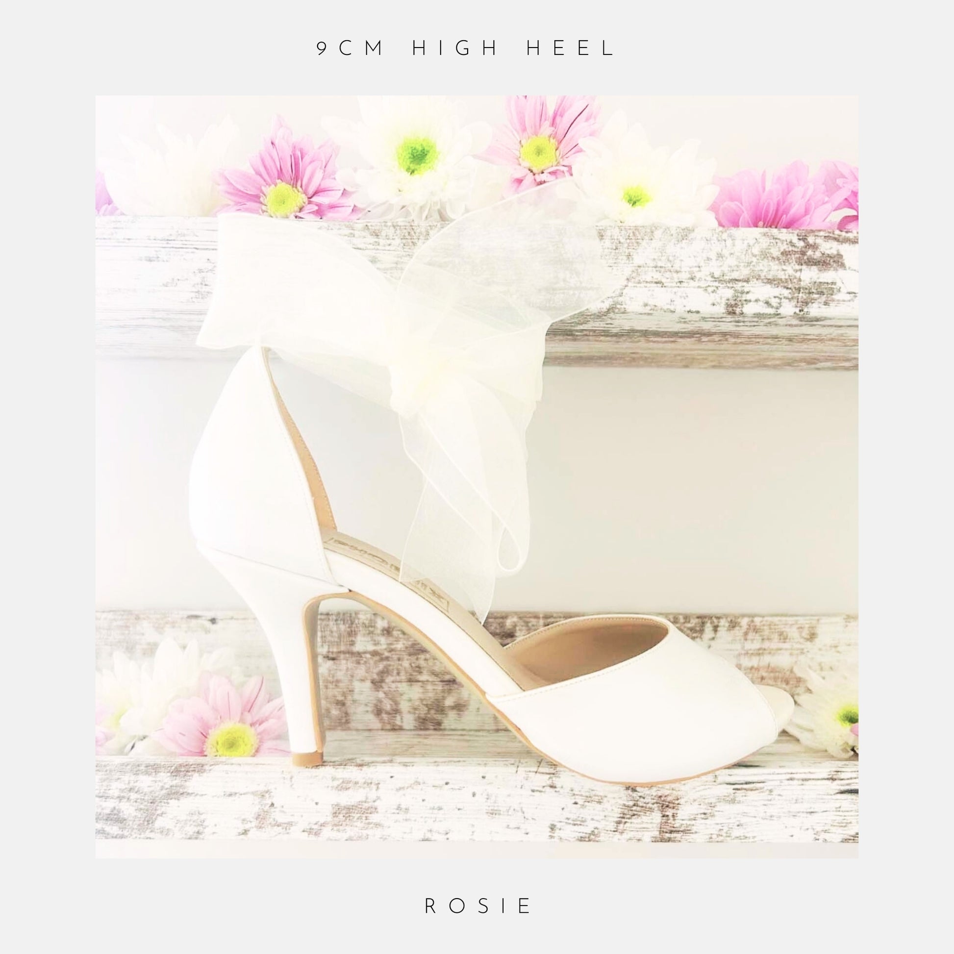 Ivory wedding shoe with floral decorations on a wooden surface with flowers.