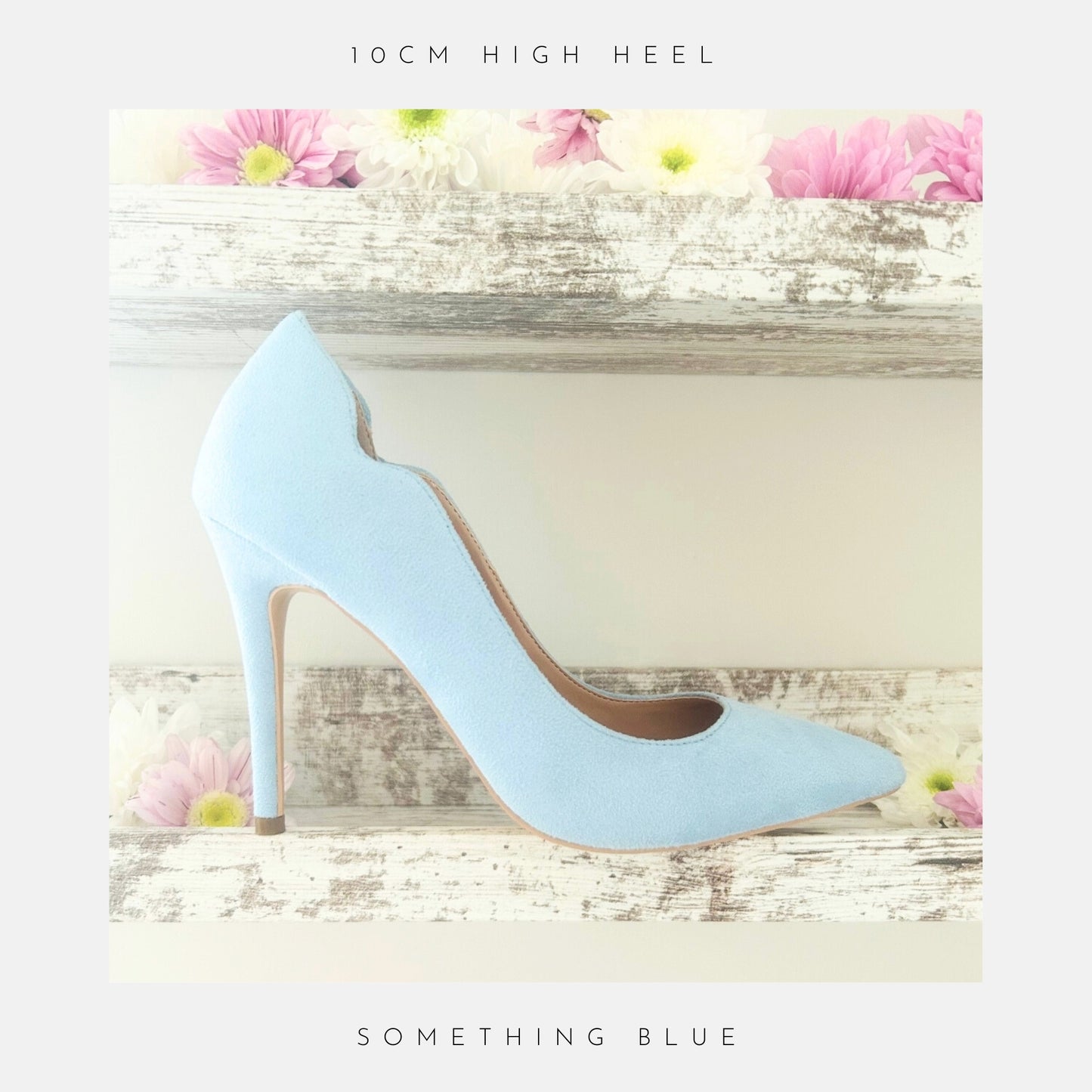 Blue faux suede high-heeled bridal shoe on a decorative wooden shelf with flowers.