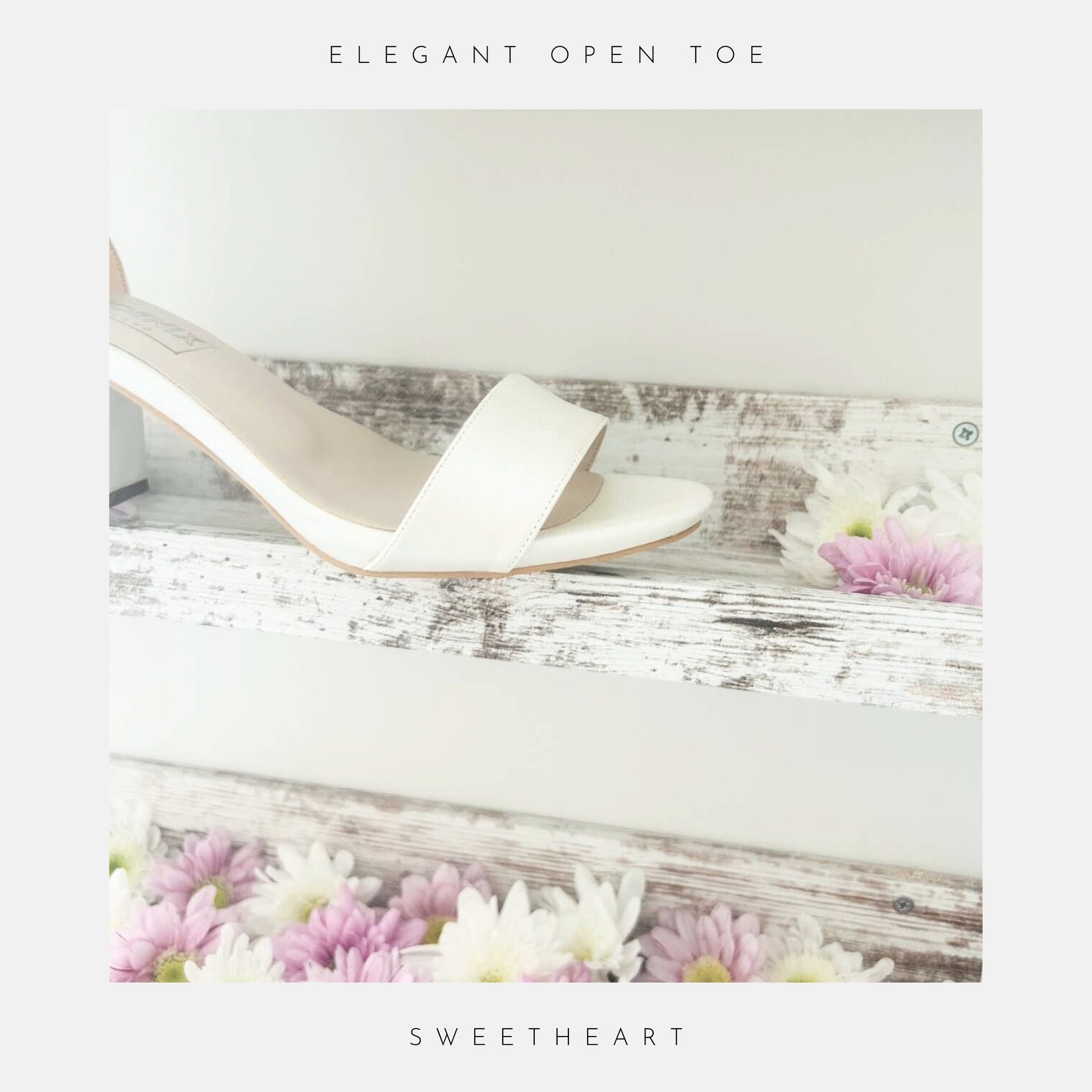 Ivory high-heeled shoe on a wooden surface with flowers, labeled 'Elegant Open Toe' and 'Sweetheart'.