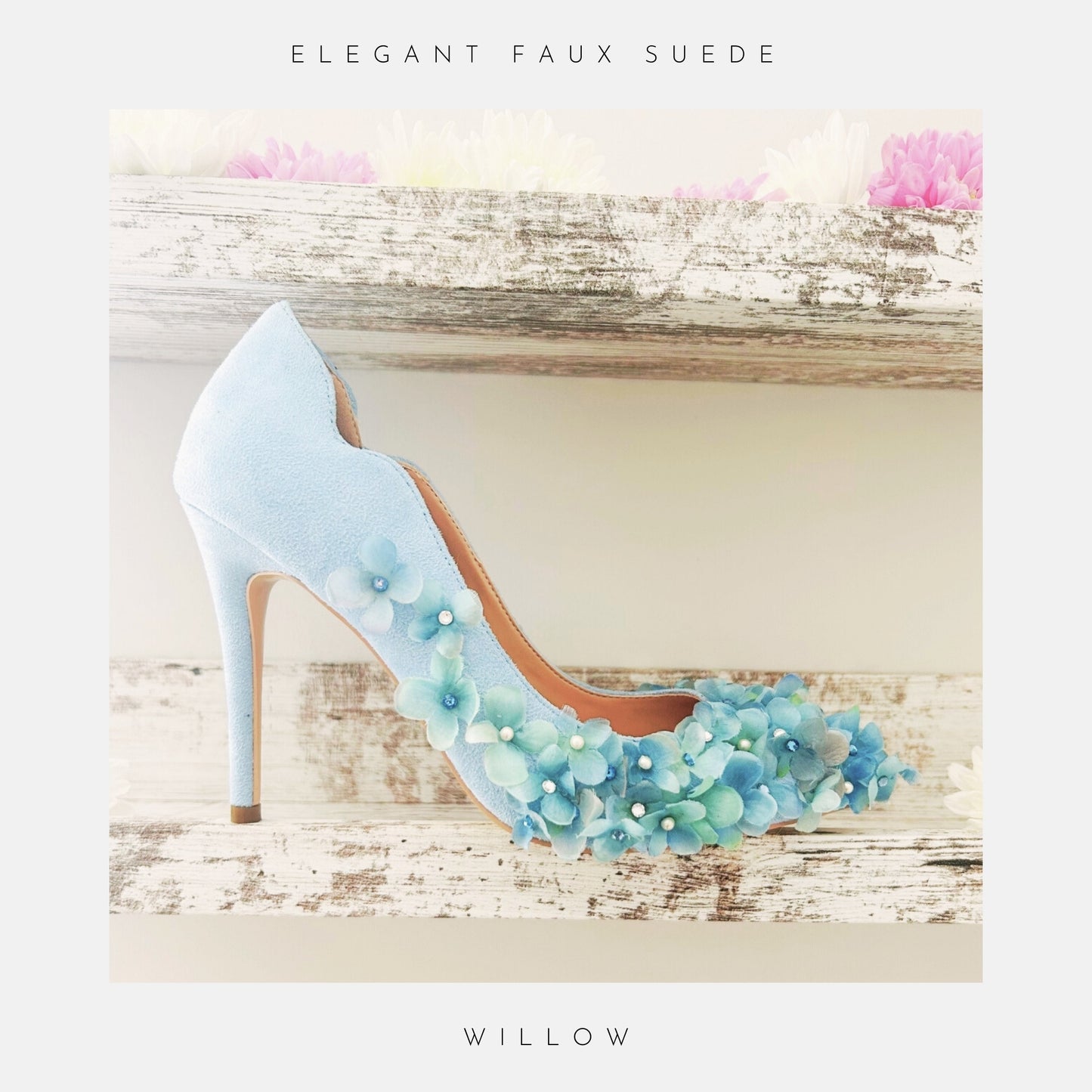 Blue high-heeled bridal shoe with floral decorations on a wooden surface, labelled 'Elegant Faux Suede' and 'Willow'.