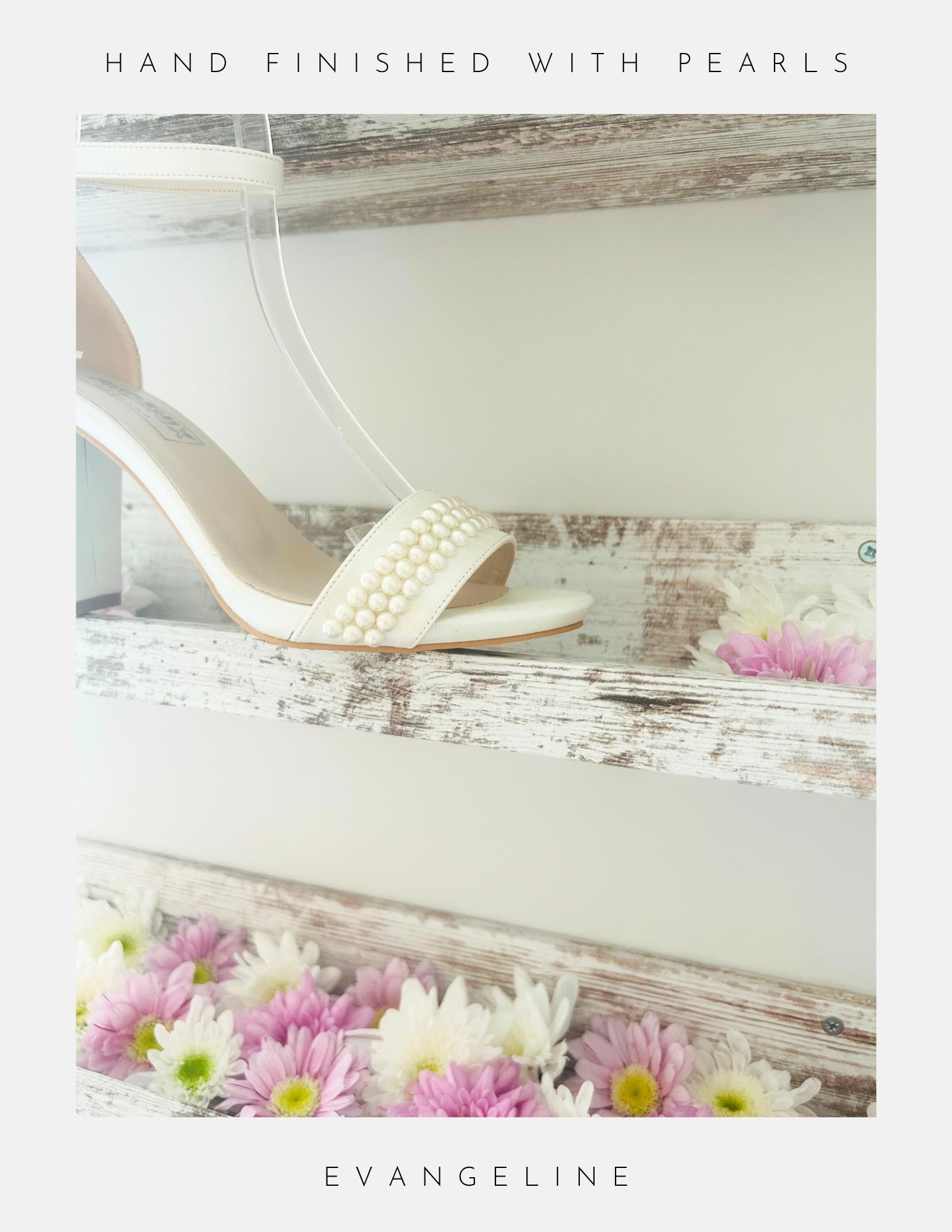 The Evangeline Pearl Block Heel Wedding Shoes by Phoenix England, hand-finished with pearls, are displayed on a rustic wooden shelf among pink and white flowers. The text says Hand Finished with Pearls and Evangeline.