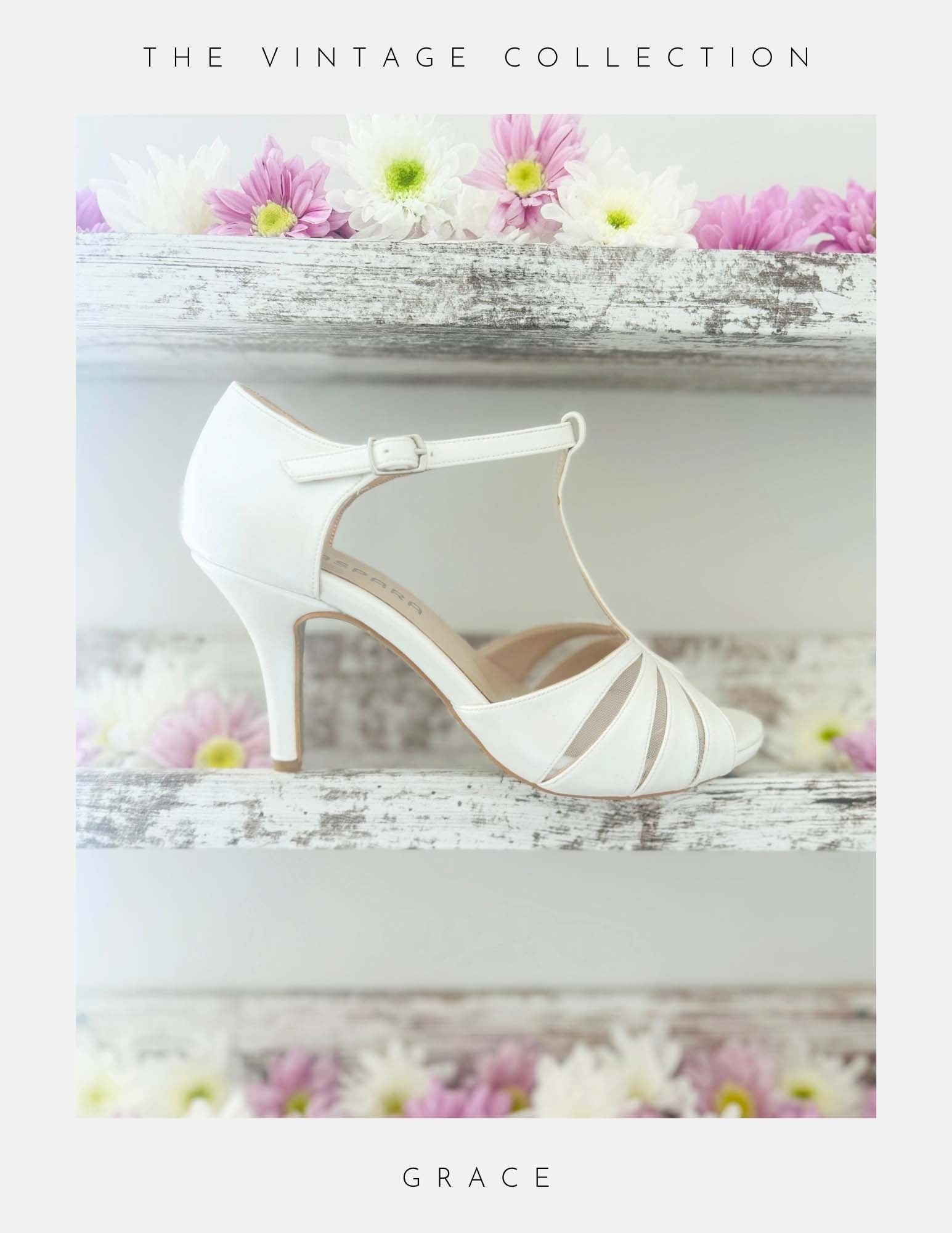 Ivory vintage inspired high-heeled shoe with floral decorations on a white surface