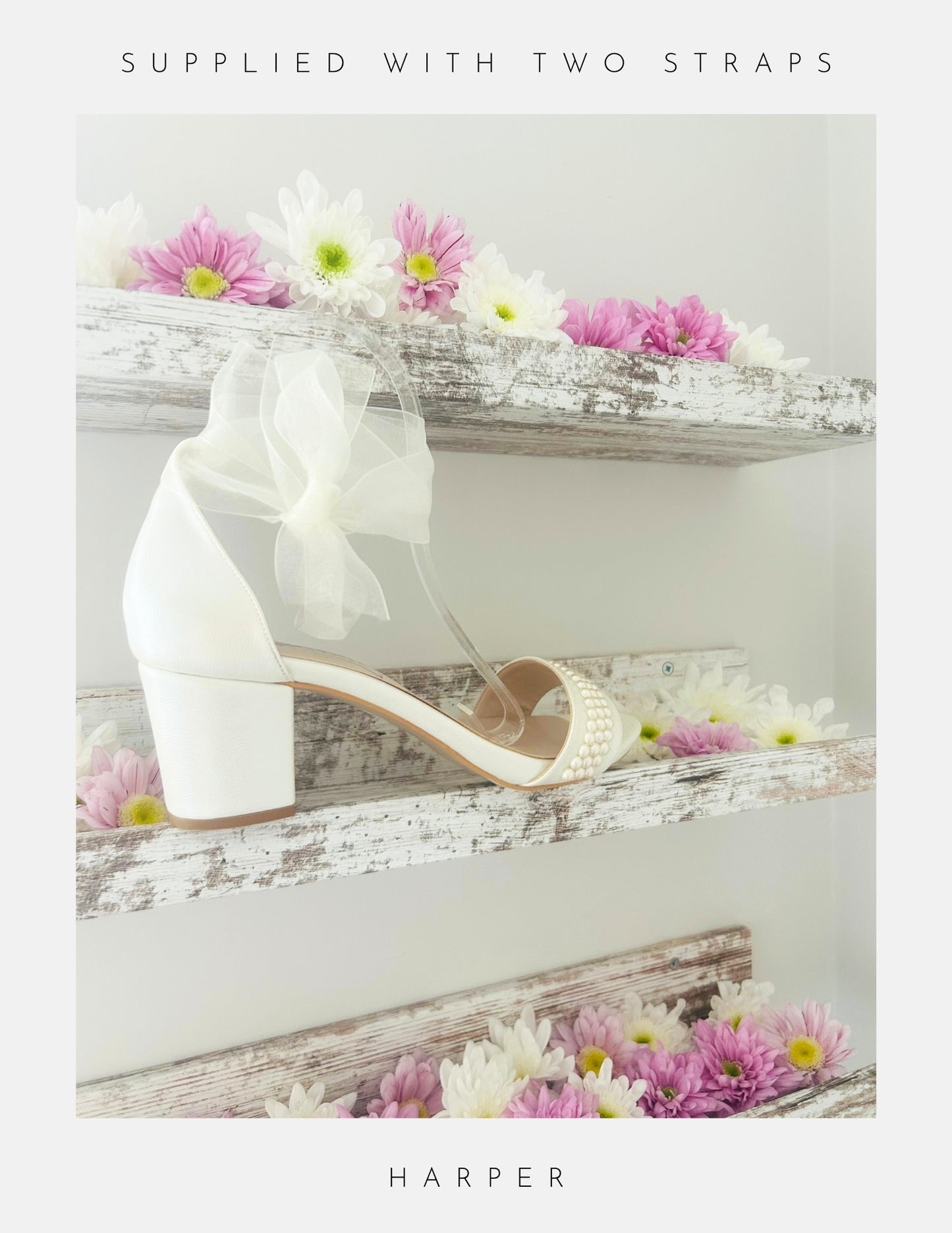 Ivory wedding sandal with an organza bow on a decorative surface with flowers