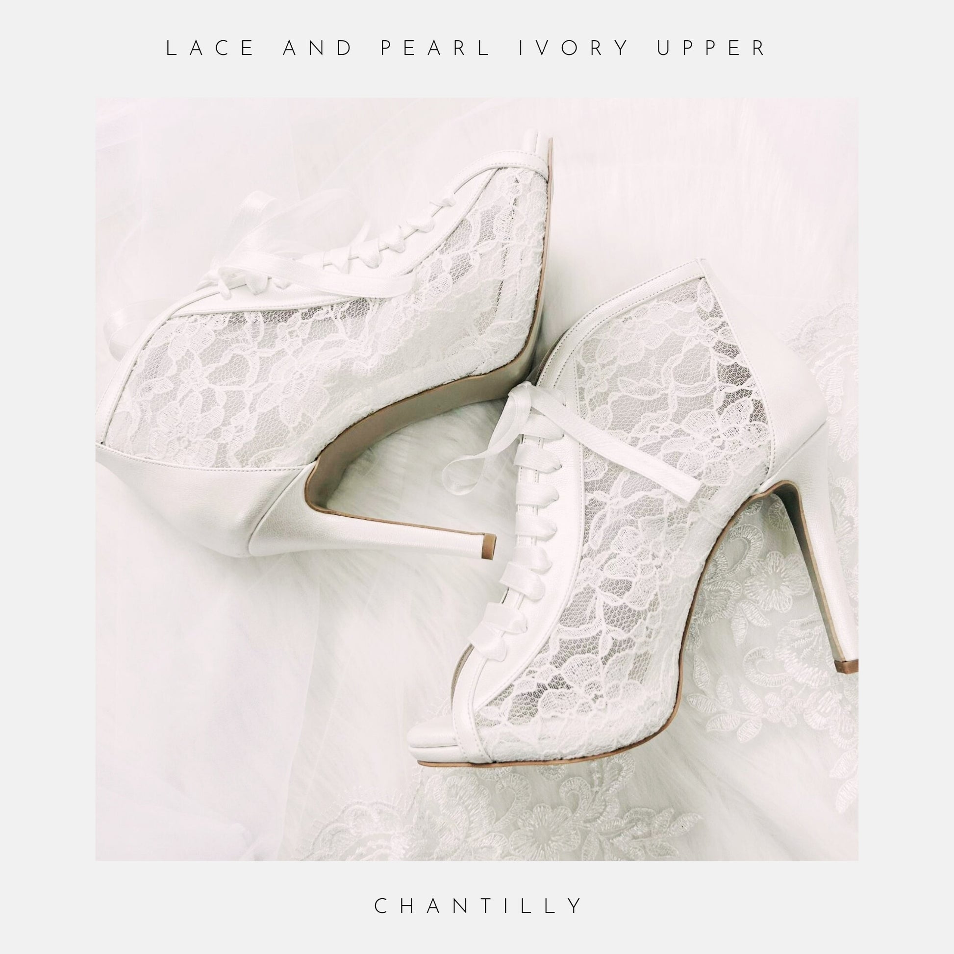 The Phoenix England Chantilly Wedding Shoes feature white Chantilly lace, ribbon laces, and peep toes, beautifully displayed on sheer, delicate fabric.