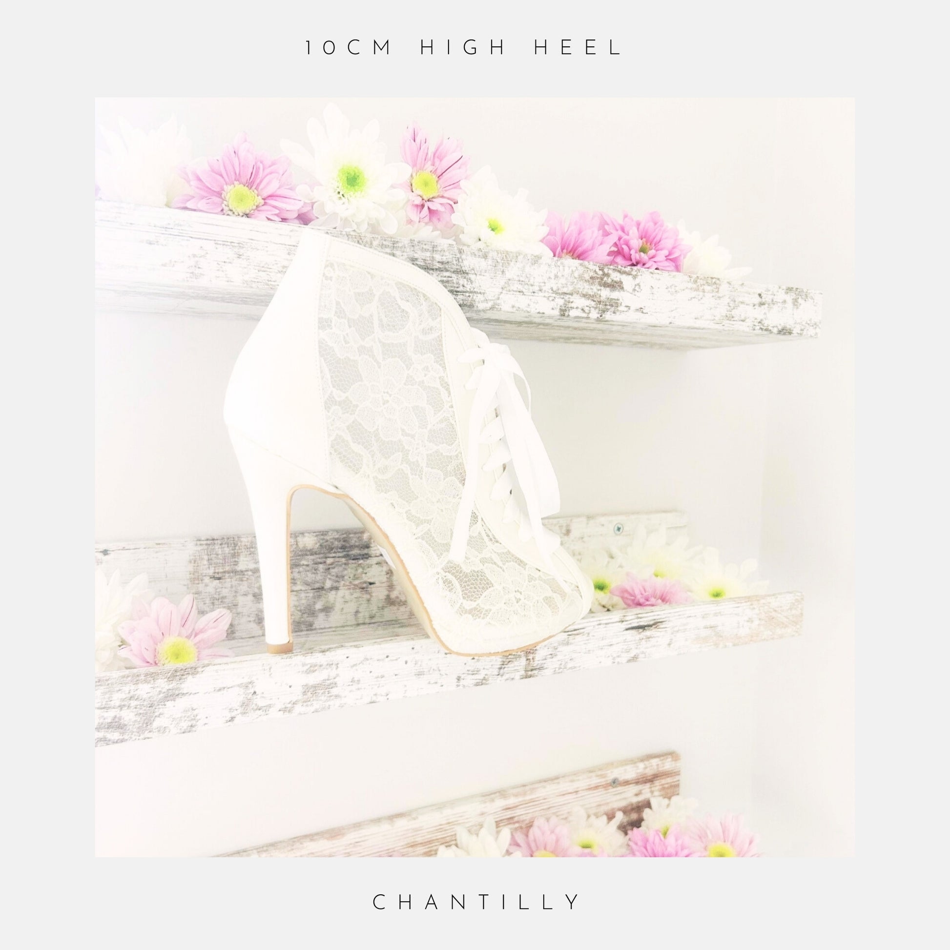 Ivory lace high heel bridal boot on a decorative shelf with flowers, with the wording 10cm heel height and Chantilly